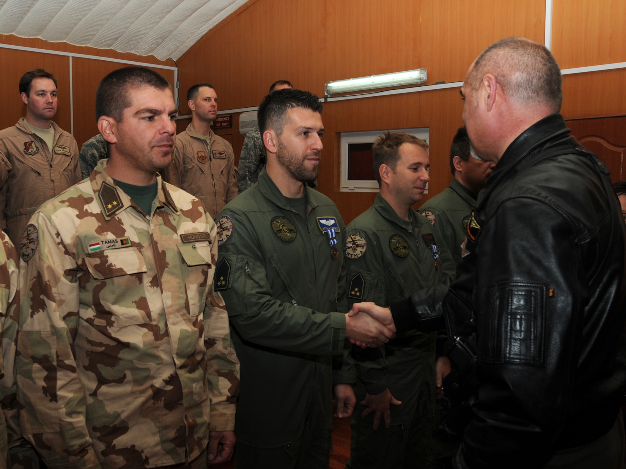 Hungarian Air Force Airmen serving with the 438th Air Expeditionary Advisory Squadron receive NATO medals from Gen. Killian, commander of the Kabul International Airport, during a ceremony marking the transition of responsibility from one group of Hungarians to another. (Photo by Mass Communications Specialist 3rd Class Jared Walker/RELEASED).