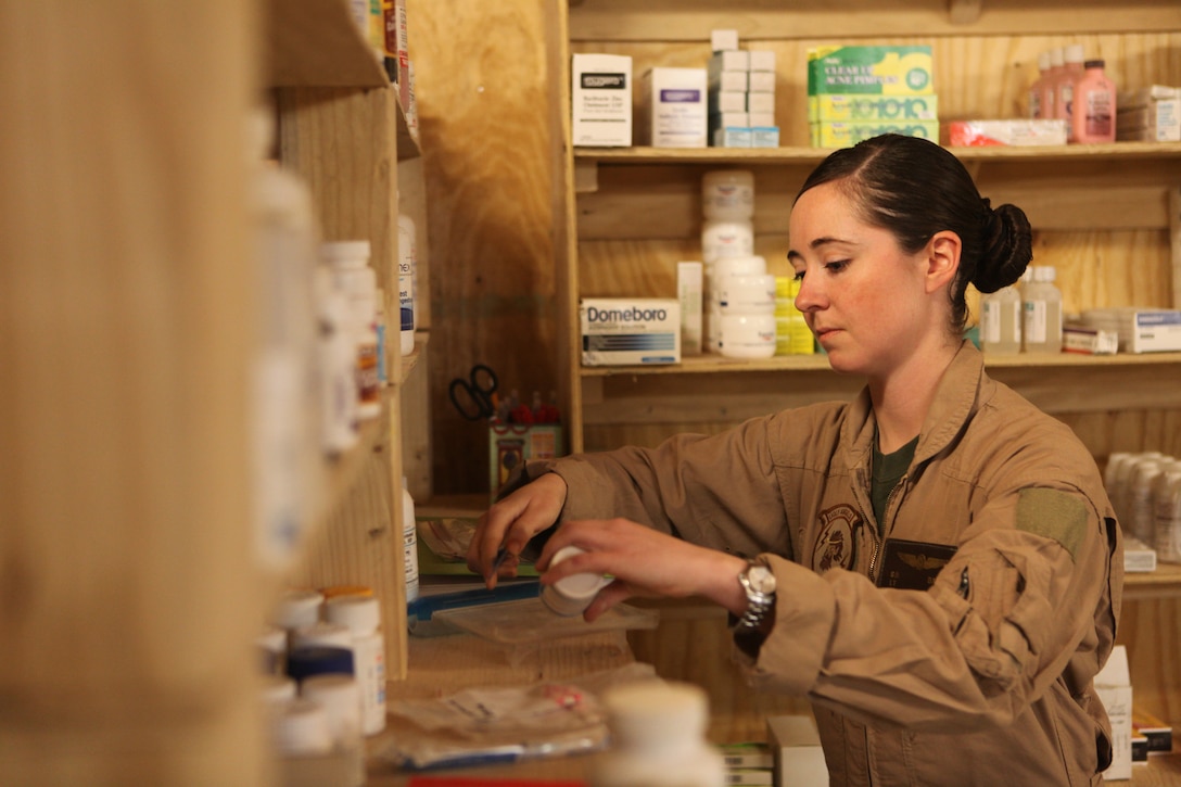 Navy Lt. Sarah Ballard readies a prescription for one of her Marines with Marine Heavy Helicopter Squadron 352, 3rd Marine Aircraft Wing (Forward), at the Flightline Aid Station aboard Camp Bastion, Afghanistan, Jan. 17.  Ballard was selected for the Richard Luehrs Memorial Award as the operational flight surgeon of the year for her superior dedication and accomplishments while deployed.