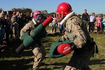 Teachers and school administrators watch two recruits conduct pugil sticks training Jan. 18 during the 2011 Recruiting Station Twin Cities Educators' Workshop. Pugil Sticks training simulates hand-to-hand combat and is an important step on their journey from civilian to elite warrior. Thirty-seven educators from Minnesota and North Dakota attended the workshop. For more photos of the event, visit the RS Twin Cities fan page at www.facebook.com/rstwincities.