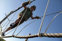 Jamie Johnson, 34, from Rochester, Minn., makes her way across one of the depot’s rope bridge obstacles Jan. 18 during the 2011 Recruiting Station Twin Cities Educators' Workshop. Johnson is the Rochester Community and Technical College Transitions Coordinator and Advisor. Thirty-seven educators from Minnesota and North Dakota attended the workshop. For more photos of the event, visit the RS Twin Cities fan page at www.facebook.com/rstwincities.