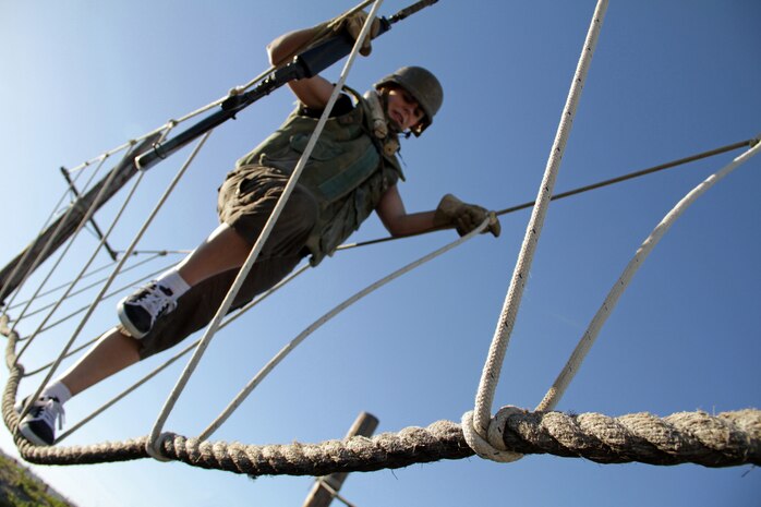 Jamie Johnson, 34, from Rochester, Minn., makes her way across one of the depot’s rope bridge obstacles Jan. 18 during the 2011 Recruiting Station Twin Cities Educators' Workshop. Johnson is the Rochester Community and Technical College Transitions Coordinator and Advisor. Thirty-seven educators from Minnesota and North Dakota attended the workshop. For more photos of the event, visit the RS Twin Cities fan page at www.facebook.com/rstwincities.