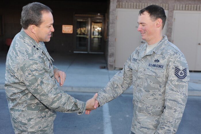 NELLIS AIR FORCE BASE, Nev.-- Maj. Gen. Timothy Byers, the Air Force Civil Engineer, presents a coin to Tech. Sgt. Stephen Styles, 99th Civil Engineer Squadron, Jan. 12. During his visit, the general also gave coins to Capt. Maureen Downen, Master Sgt. Kieran Flynn, Airman First Class Andrew Perna and Glen Taylor. (U.S. Air Force photo)