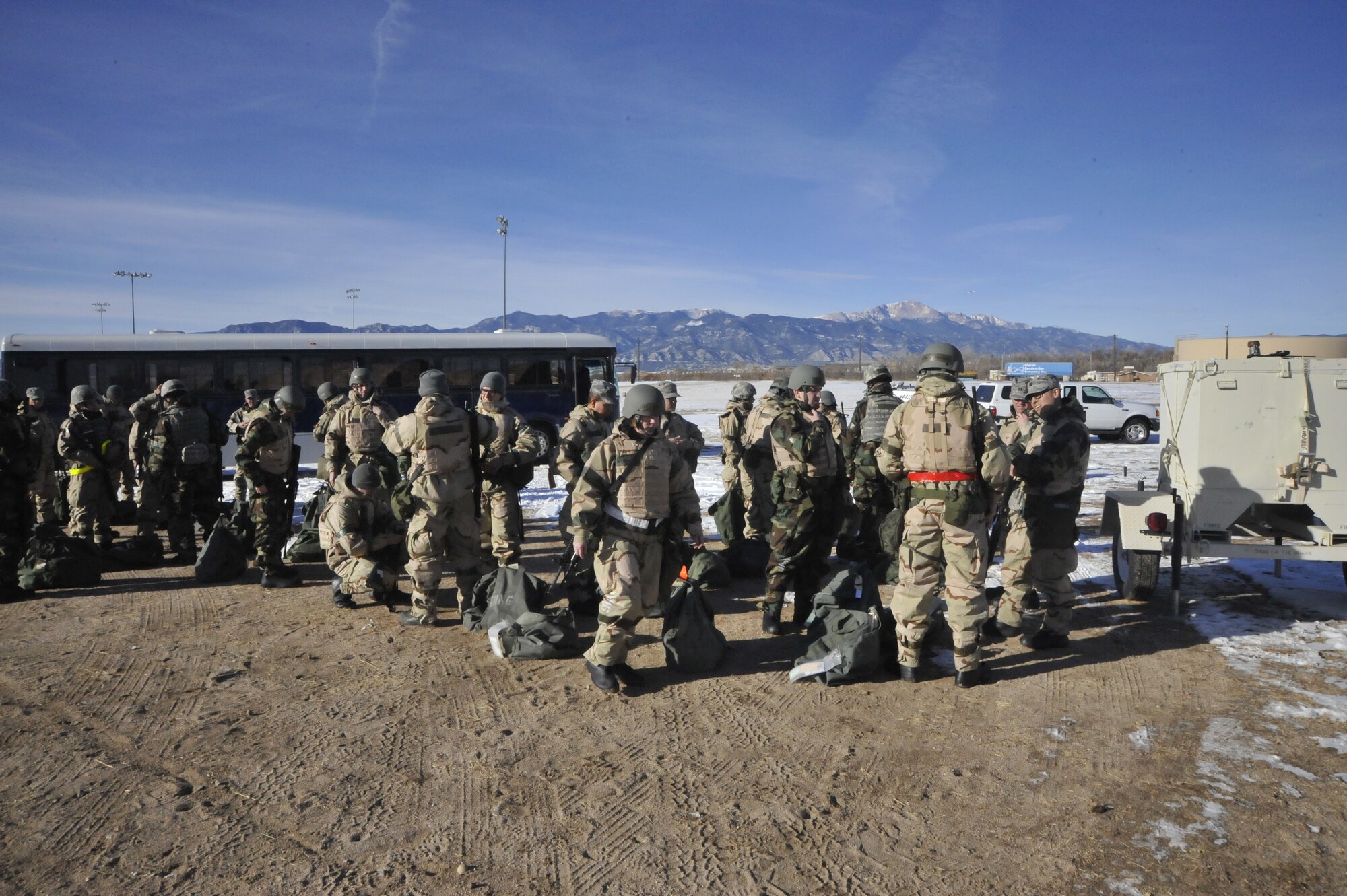 About 100 Airmen arrive at their “deployed location” Jan. 13 for the 21st Space Wing’s quarterly exercise, Condor Crest. Airmen were tested on MOPP transition, alarm reaction, attack preparation including covering assets, weapons familiarization and self aid buddy care. The 21st SW will undergo an Operational Readiness Inspection and a Unit Compliance Inspection Feb. 27 to March 21. (U.S. Air Force photo Dennis Howk)