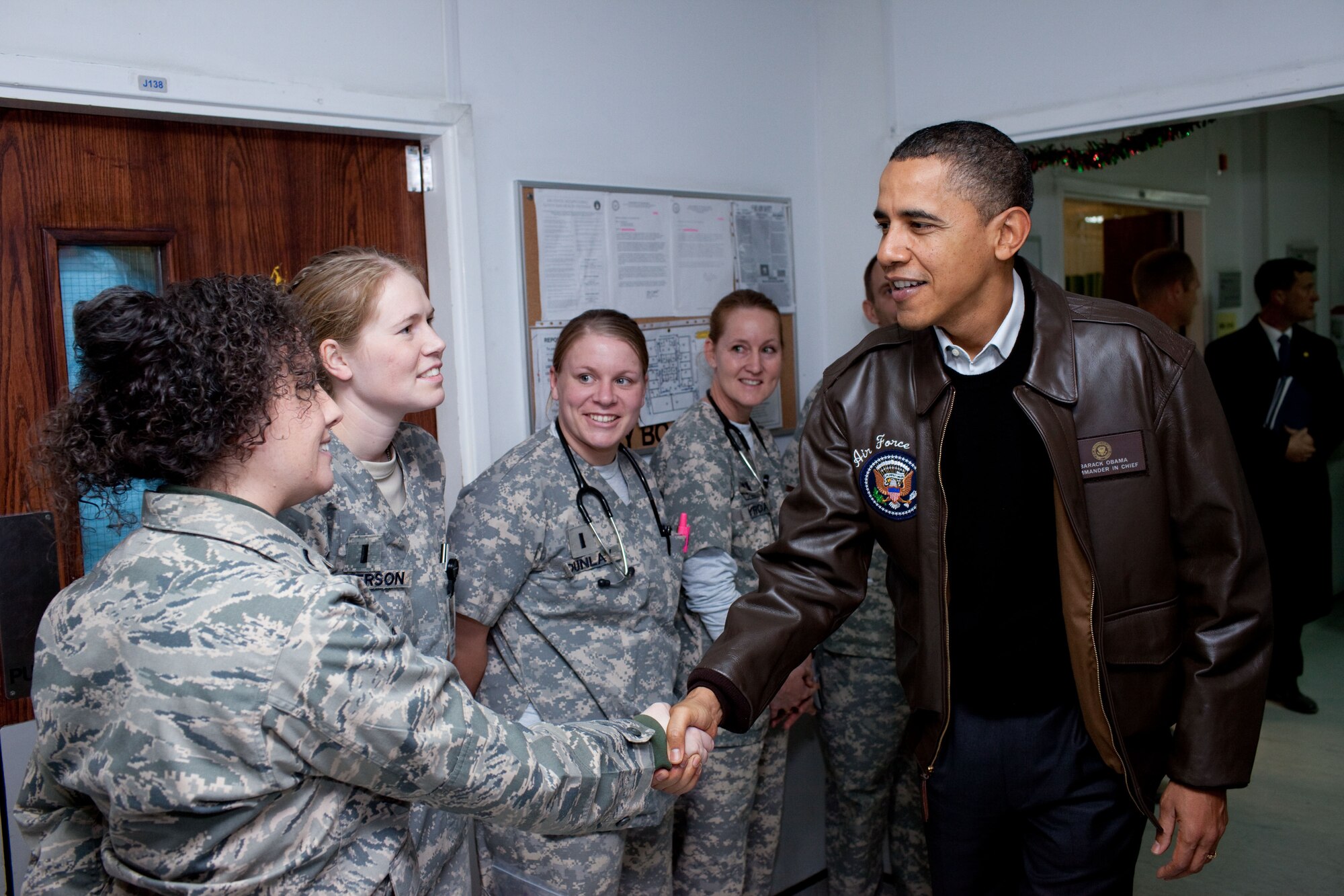 First Lt. Erin Cornman, left, 81st Inpatient Operations Squadron medical inpatient unit nurse, is among members of the 455th Expeditionary Medical Group at Bagram Air Base, Afghanistan, to meet President Barack Obama during his December visit to the hospital. The president addressed hundreds of base personnel during his visit.  (White House photo)