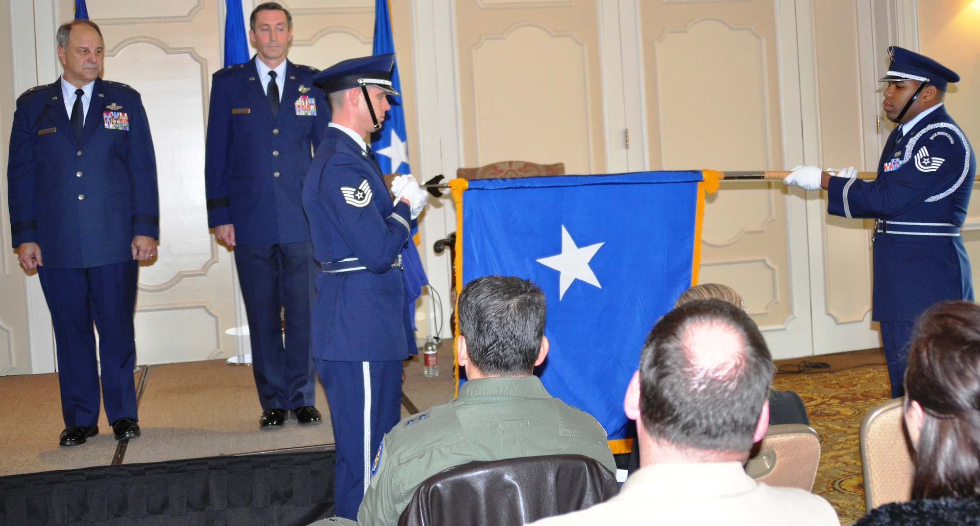 Maj. Gen. Roger Binder (left), assistant to the commander Air Combat Command, and Brig. Gen. Ronald B. Miller, 301st Fighter Wing commander, watch the unfurling of personal colors at the commander's promotion ceremony Jan. 15, 2011. The unfurling of General Miller's personal colors signify his promotion to brigadier general. 