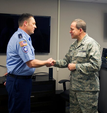 NELLIS AIR FORCE BASE, Nev.-- Maj. Gen. Timothy Byers, the Air Force Civil Engineer, presents a coin to Glen Taylor, 99th Civil Engineer Squadron lead firefighter, Jan. 12 for his direct involvement in saving a life while he was off duty. Mr. Taylor performed the Heimlich maneuver on a choking man on Christmas Eve at a local restaurant. During his visit, the general also gave coins to Capt. Maureen Downen, Master Sgt. Kieran Flynn, Tech. Sgt. Stephen Styles and Airman 1st Class Andrew Perna. (U.S. Air Force photo)
