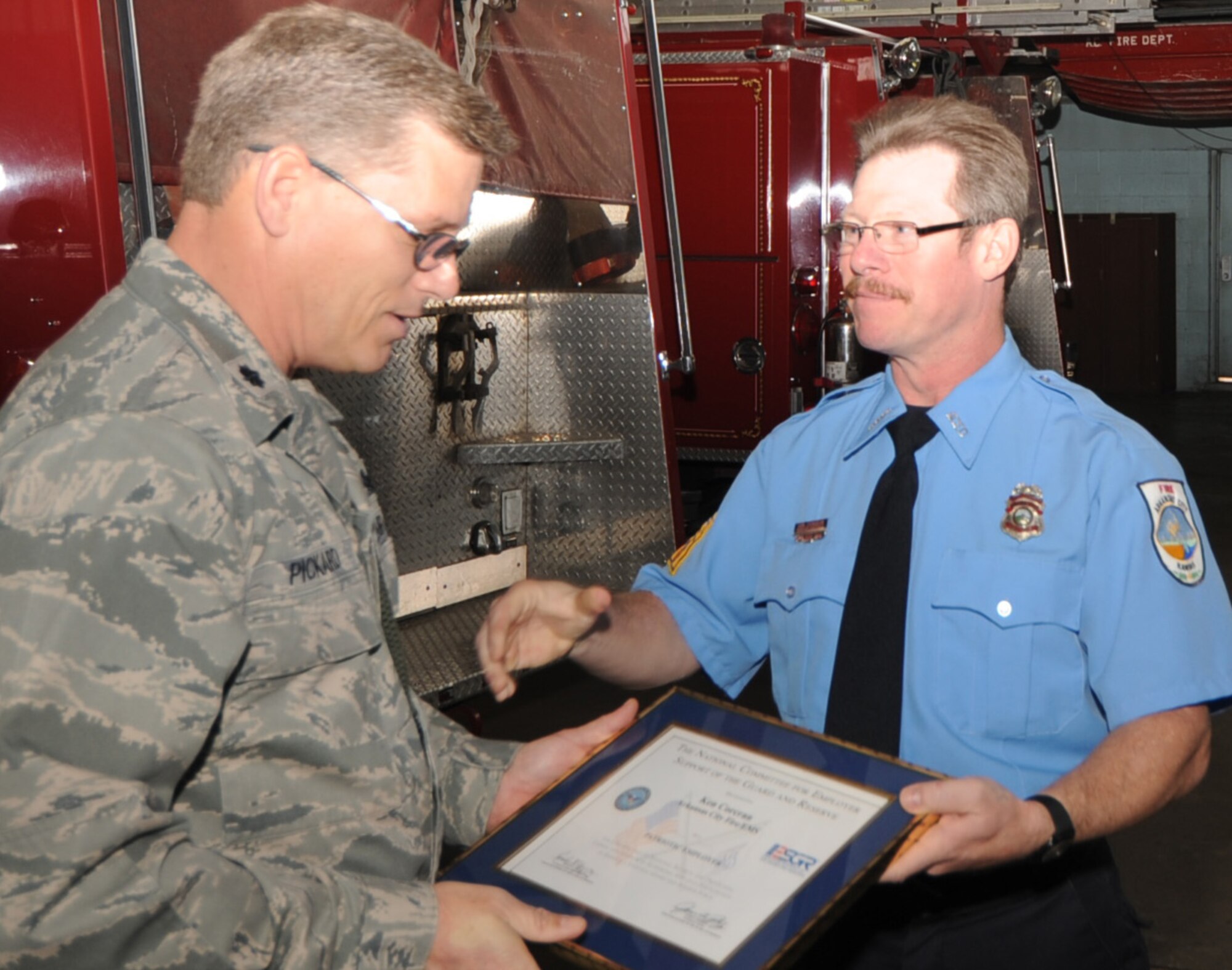 Lt. Colonel Jeffrey Pickard, Deputy Commander for Maintenance, 931st ARG presents the Patriot Award to Ken Corcran, fire chief, Arkansas City Fire and EMT. Mr. Corcran was nominated for the award by Staff Sgt. Edward Allred, 931st Civil Engineering Squadron. Colonel Pickard presented the award on behalf of the 931st ARG commander Col. Edsel Frye, and Lieutenant Col. Erin Manning, 931st CES. Sergeant Allred and Colonel Manning are currently deployed. 