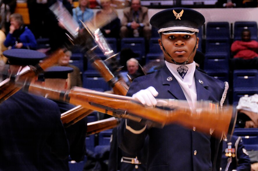AIR FORCE DISTRICT OF WASHINGTON – Air Force Senior Airman Doyle Boyd, U.S. Air Force Honor Guard Drill Team member, performs maneuvers during a half-time show at the George Washington University men’s basketball game Jan. 12 at the Smith Center in Washington, D.C. The men and women who serve were saluted by the audience during Military Appreciation Night at the game. (U.S. Air Force photo by Senior Airman Steele C. G. Britton)