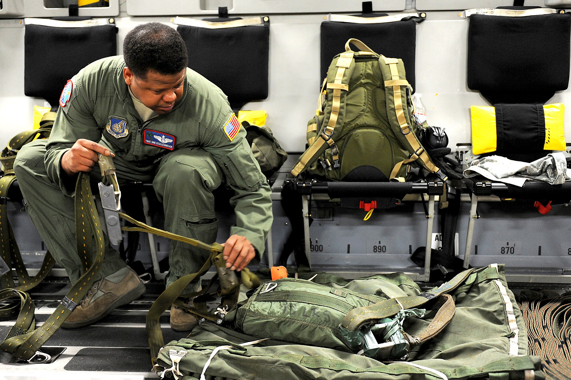 Tech. Sgt. Dre Stollenwerck prepares a parachute for an airdrop mission Jan. 11, 2011, over Andersen Air Base, Guam. Aircrews from the 535th Airlift Squadron dropped nine training pallets during a single day of airdrop training. The aircrew then helped the 36th Contingency Response Group with static line jump training. Sergeant Stollenwerck is with the 535th AS. (U.S. Air Force photo/Staff Sgt. Mike Meares)