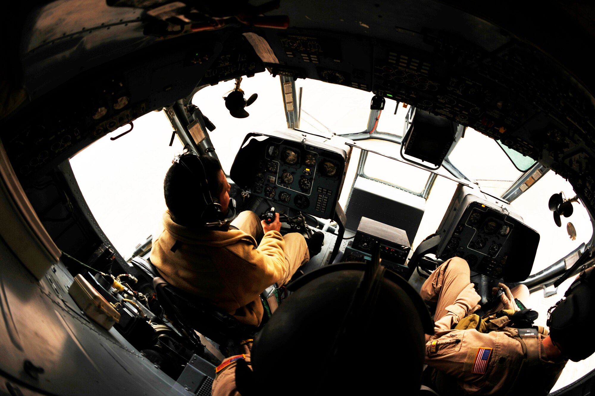 Afghan air force Capt. Hamid practices emergency procedures with instruction from Maj. Drew Grigson during a proficiency flight aboard an Mi-17 Jan 10, 2011, at Shindand Air Base, Afghanistan. Captain  Hamid is part of the first class of pilots to attend a pilot training course taught by Airmen from the 444th AEAS. Major Grigson is from the 444th Air Expeditionary Advisory Squadron. (U.S. Air Force photo/Staff Sgt. Eric Harris) 
