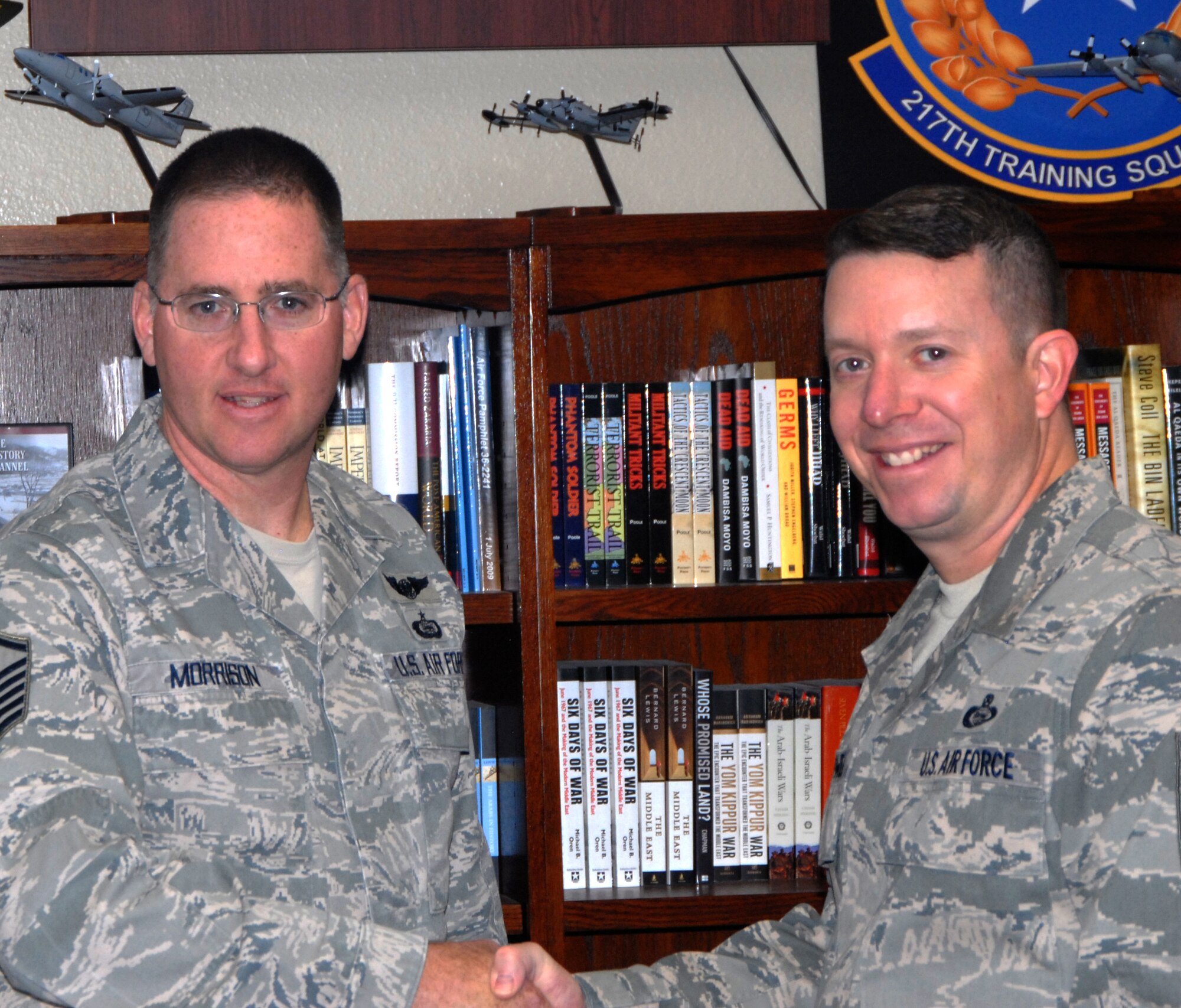 GOODFELLOW AIR FORCE BASE, Texas -- Chief Master Sgt. Brendan Criswell, 17th Training Wing Command Chief, presents Master Sgt. Sean Morrison, 217th Training Squadron, with a Command Chief Coin Jan. 13 for his win as 2010 Texas Air National Guard Outstand SNCO of the Year. (U.S. Air Force photo/Connie Hempel)