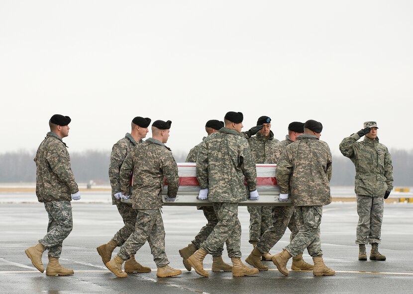 A U.S. Army carry team transfers the remains of Army Spc. Jose A. Torre Jr. of Garden Grove, Calif., at Dover Air Force Base, Del., Jan. 18, 2011.  Torre was assigned to the Special Troops Battalion, 2nd Advise and Assist Brigade, 1st Infantry Division, Fort Riley, Kan.    (U.S. Air Force photo/Jason Minto)