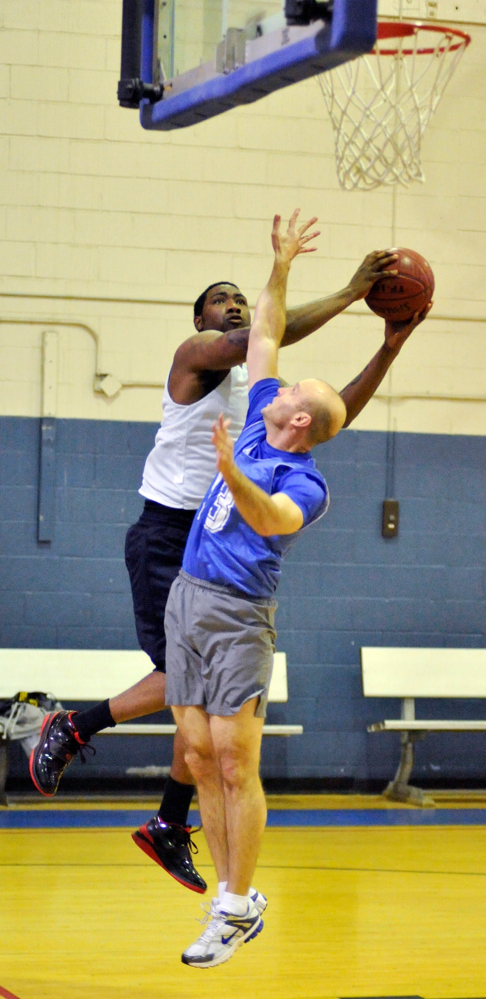 Maurice Neal Jr. attempts a hard layup at the Fitness Center as Anthony Krawietz defends. The 436th Aircraft Maintenance Squadron lost to the 436th Comptroller Squadron in a showdown Jan. 13 56-33. (U.S. Air Force photo/Airman 1st Class Jacob Morgan) 