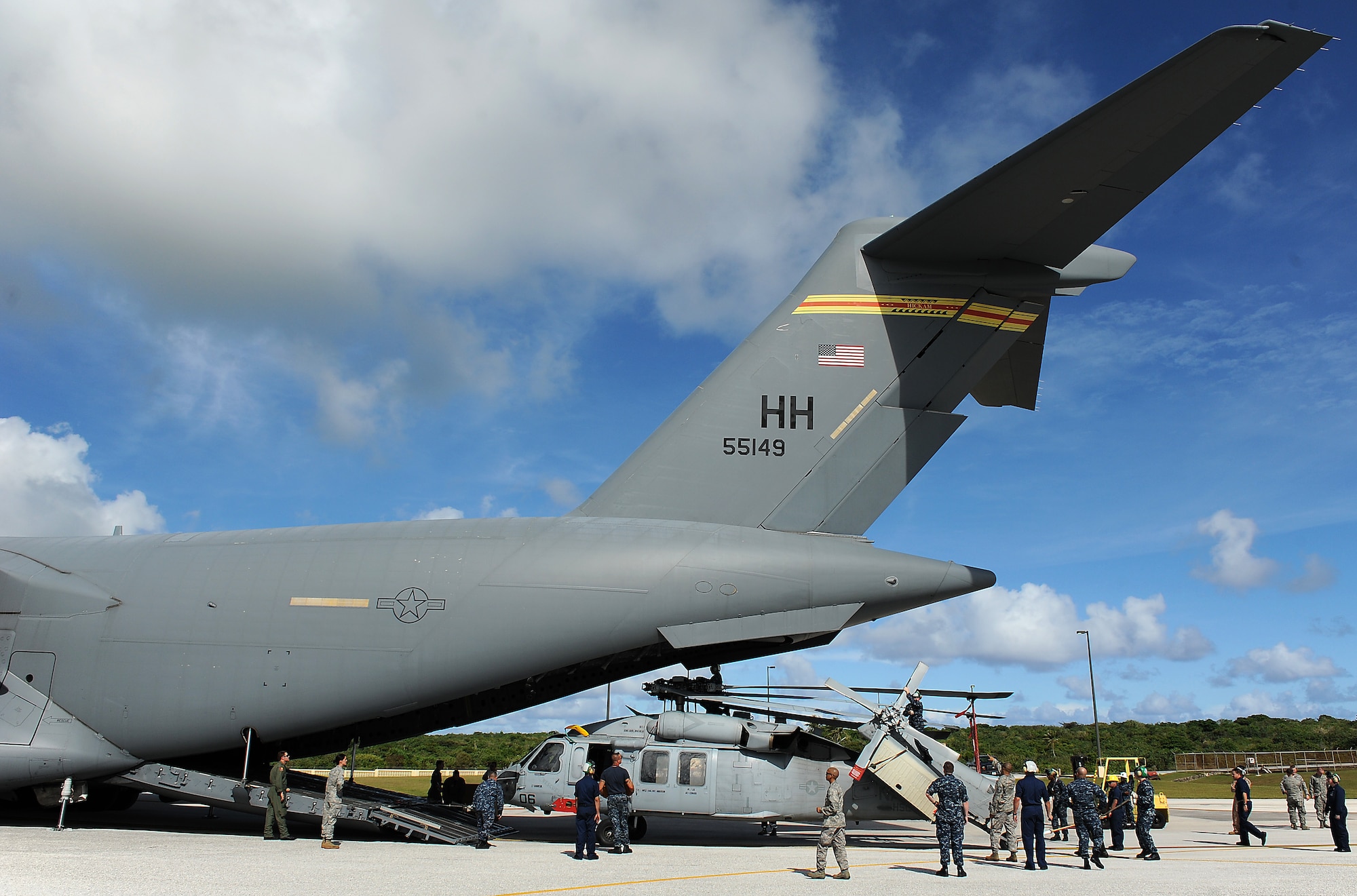 Airmen and Sailors from the 36th Contingency Response Group, Andersen Air Force Base, Guam, practice loading a helicopter onto a C-17 Globemaster III from Joint Base Pearl Harbor-Hickam, Hawaii, Jan. 13. The Aircrew from the 535th Airlift Squadron maximized their airdrop and training opportunities while visiting Guam by dropping airdropping paratroopers, nine training pallets and a boat. (U.S. Air Force photo/Staff Sgt. Mike Meares) 