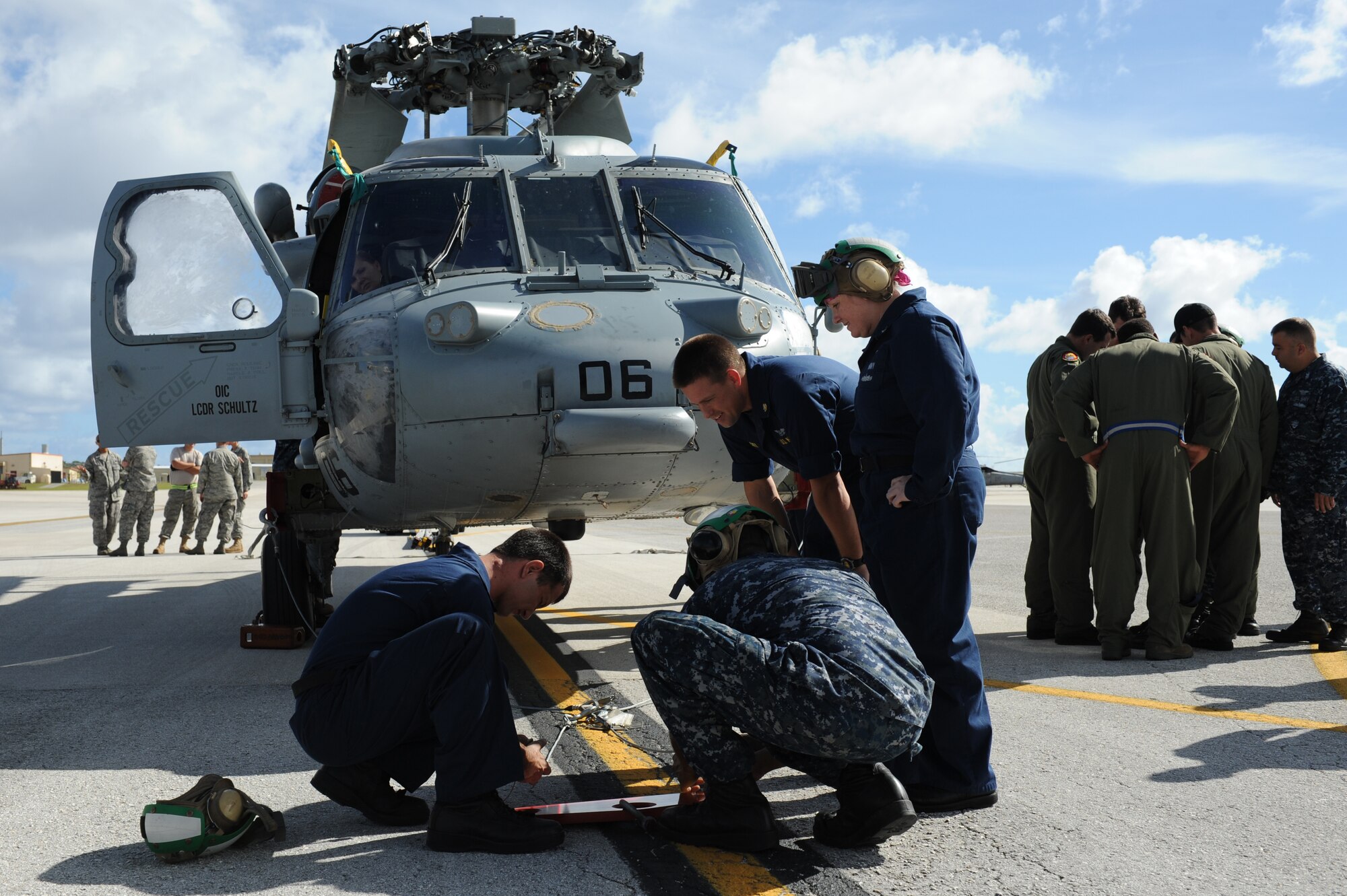 Airmen and Sailors from the 36th Contingency Response Group, Andersen Air Force Base, Guam, practice loading a helicopter onto a C-17 Globemaster III from Joint Base Pearl Harbor-Hickam, Hawaii, Jan. 13. The Aircrew from the 535th Airlift Squadron maximized their airdrop and training opportunities while visiting Guam by dropping airdropping paratroopers, nine training pallets and a boat. (U.S. Air Force photo/Staff Sgt. Mike Meares) 