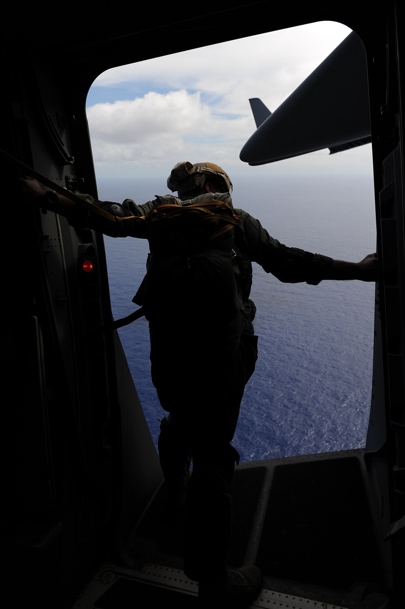 A 36th Contingency Response Group jumpmaster surveys the drop zone during proficiency training Jan. 13.  Hickam aircrew from the 535th Airlift Squadron provided four static line jumps for the 36th CRG?s proficiency training over two separate days. (U.S. Air Force photo/Staff Sgt. Mike Meares)