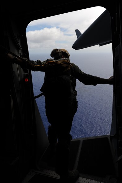 A 36th Contingency Response Group jumpmaster surveys the drop zone during proficiency training Jan. 13.  Hickam aircrew from the 535th Airlift Squadron provided four static line jumps for the 36th CRG?s proficiency training over two separate days. (U.S. Air Force photo/Staff Sgt. Mike Meares)