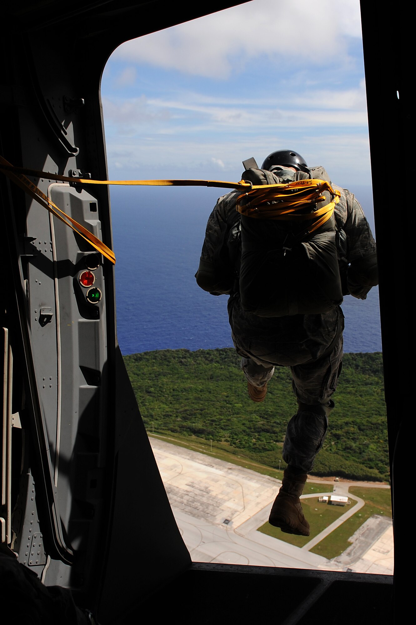 Airmen from the 36th Contingency Response Group jump from the troop door of a 535th Airlift Squadron C-17 Globemaster III from Joint Base Pearl Harbor-Hickam, Hawaii, over the Andersen Air Force Base, Guam, drop zone Jan. 13 during static line jump proficiency training.  The Hickam aircrew provided four separate jumps for the 36th CRG Airmen. (U.S. Air Force photo/Staff Sgt. Mike Meares)