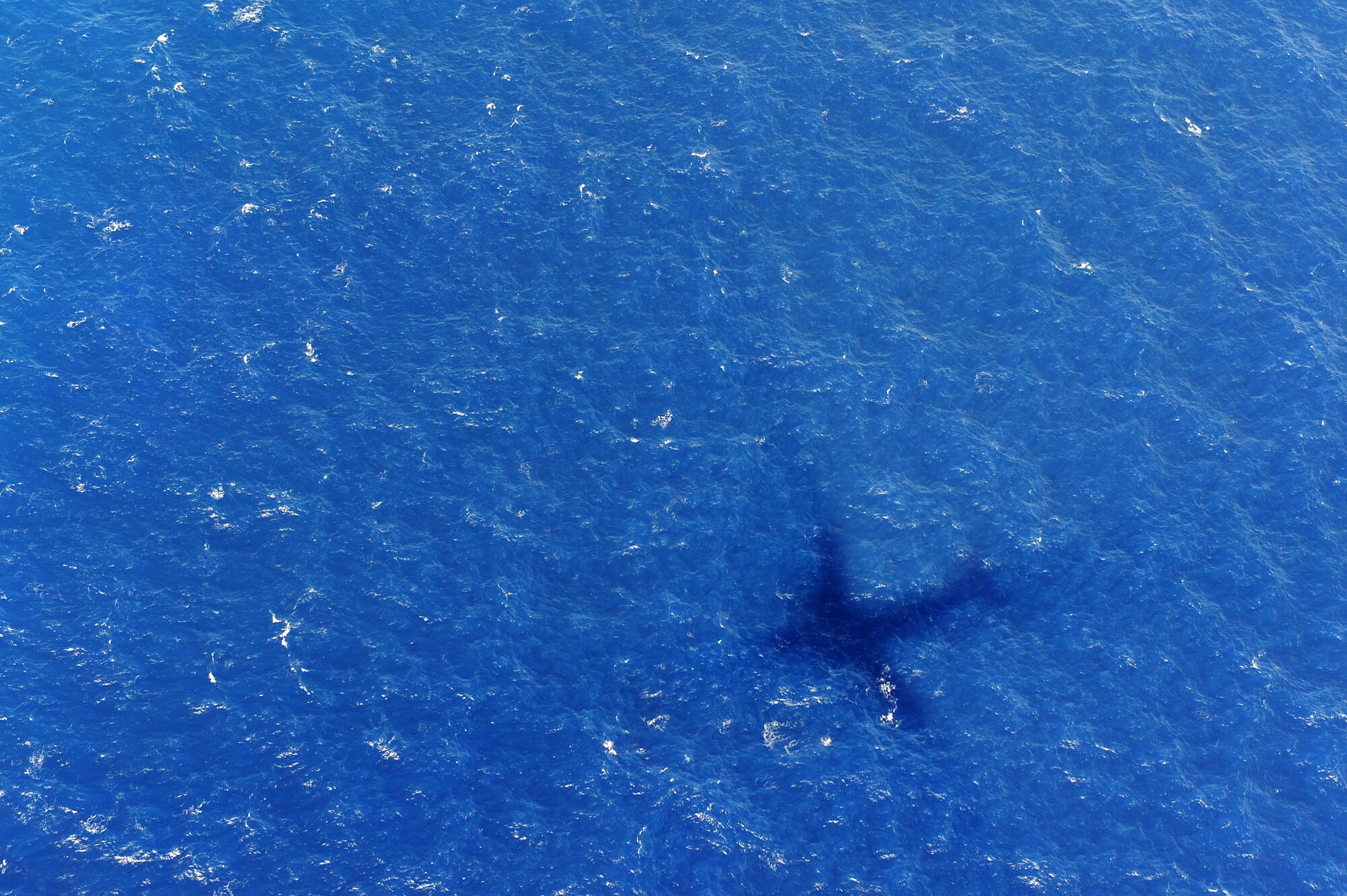 A 535th Airlift Squadron C-17 Globemaster III from Joint Base Pearl Harbor-Hickam, Hawaii, approaches the drop zone from the coast of Andersen Air Force Base, Guam, Jan. 13 while providing static line jump proficiency training for members of the 36th Contingency Response Group.  The Hickam aircrew provided four separate jumps for the 36th CRG Airmen. (U.S. Air Force photo/Staff Sgt. Mike Meares)