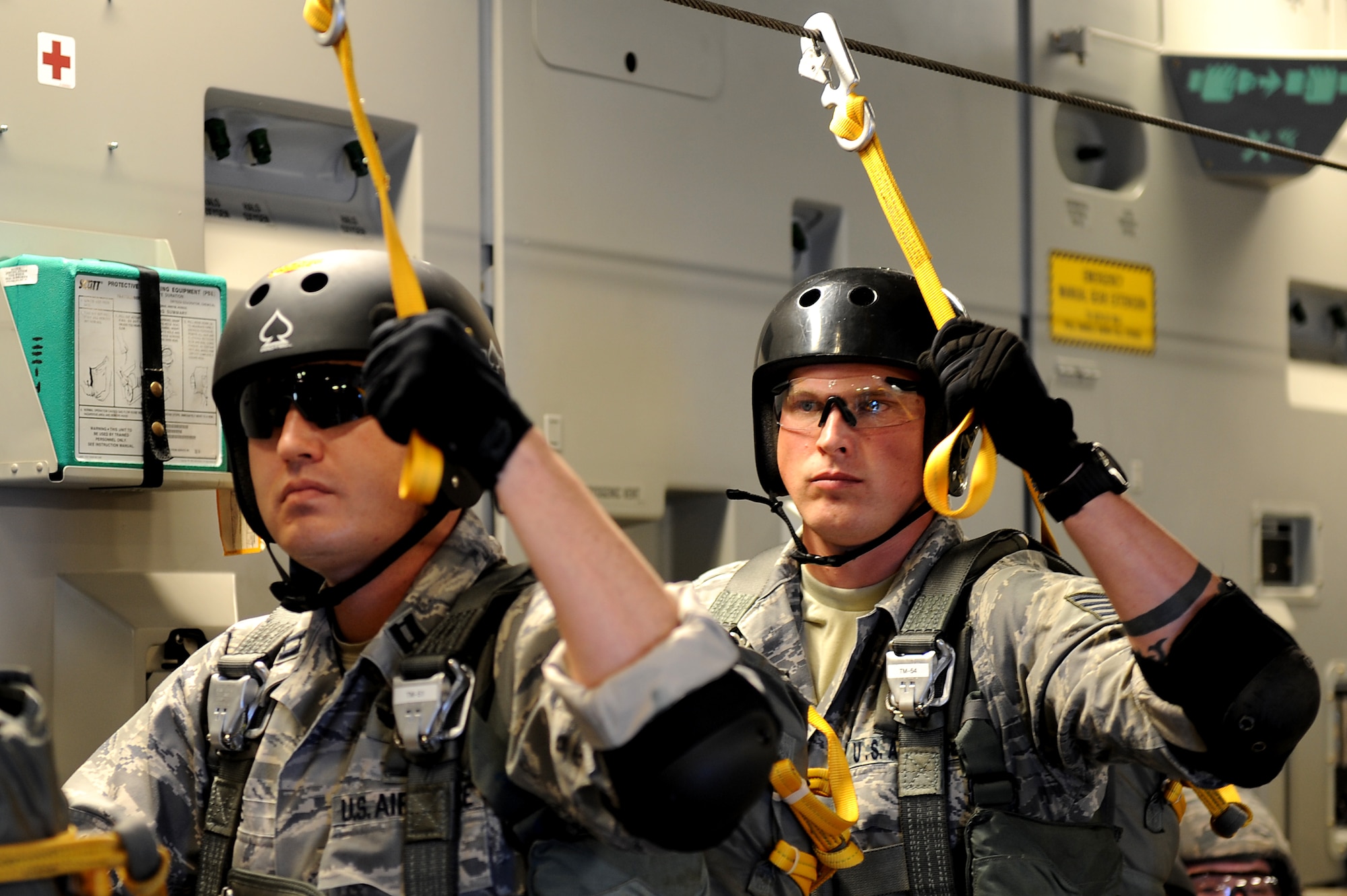 Airmen from the 36th Contingency Response Group jump from the troop door of a 535th Airlift Squadron C-17 Globemaster III from Joint Base Pearl Harbor-Hickam, Hawaii, over the Andersen Air Force Base, Guam, drop zone Jan. 13 during static line jump proficiency training.  The Hickam aircrew provided four separate jumps for the 36th CRG Airmen. (U.S. Air Force photo/Staff Sgt. Mike Meares)
