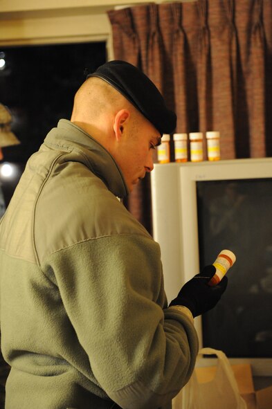 DYESS AIR FORCE BASE, Texas—Tech. Sgt. Jeremy Kennon, 7th Security Forces Squadron, looks over medication bottles found in a dorm room Jan. 18 at Gaylor Hall here. Col. David Béen, 7th Bomb Wing commander, directed a morale, health and welfare inspection in an effort to enforce zero tolerance for misconduct or misbehavior. During this inspection, dorm residents were taken for drug testing while their rooms were inspected by first sergeants and military working dogs for drugs, weapons and other unauthorized items. (U.S Air Force photo/ Airman 1st Class Shannon Hall)