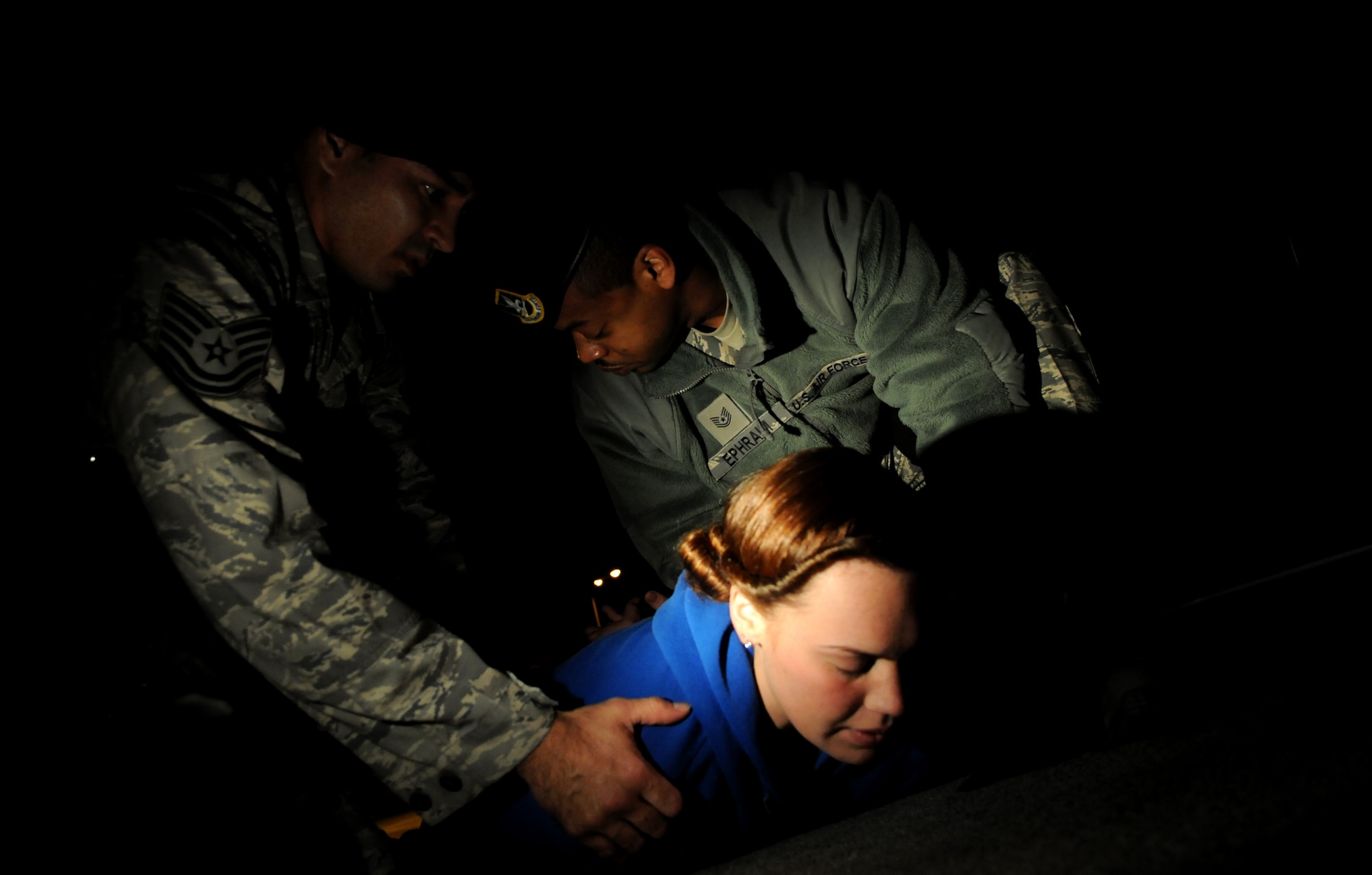 Tech.Sgt.James Lewis, an assistant flight chief and Tech. Sgt. Rashaan Epraim, a flight chief with the 18th Security Forces Squadron apprehend a suspect who allegedly ''assaulted'' her boyfriend as part of an exercise at Kadena Air Base, Japan, Jan 18. Kadena personnel are participating in exercise Beverly High 11-02 to stay prepared for real world contingencies. (U.S. Air Force photo/Airman 1st Class Jarvie Z. Wallace)
