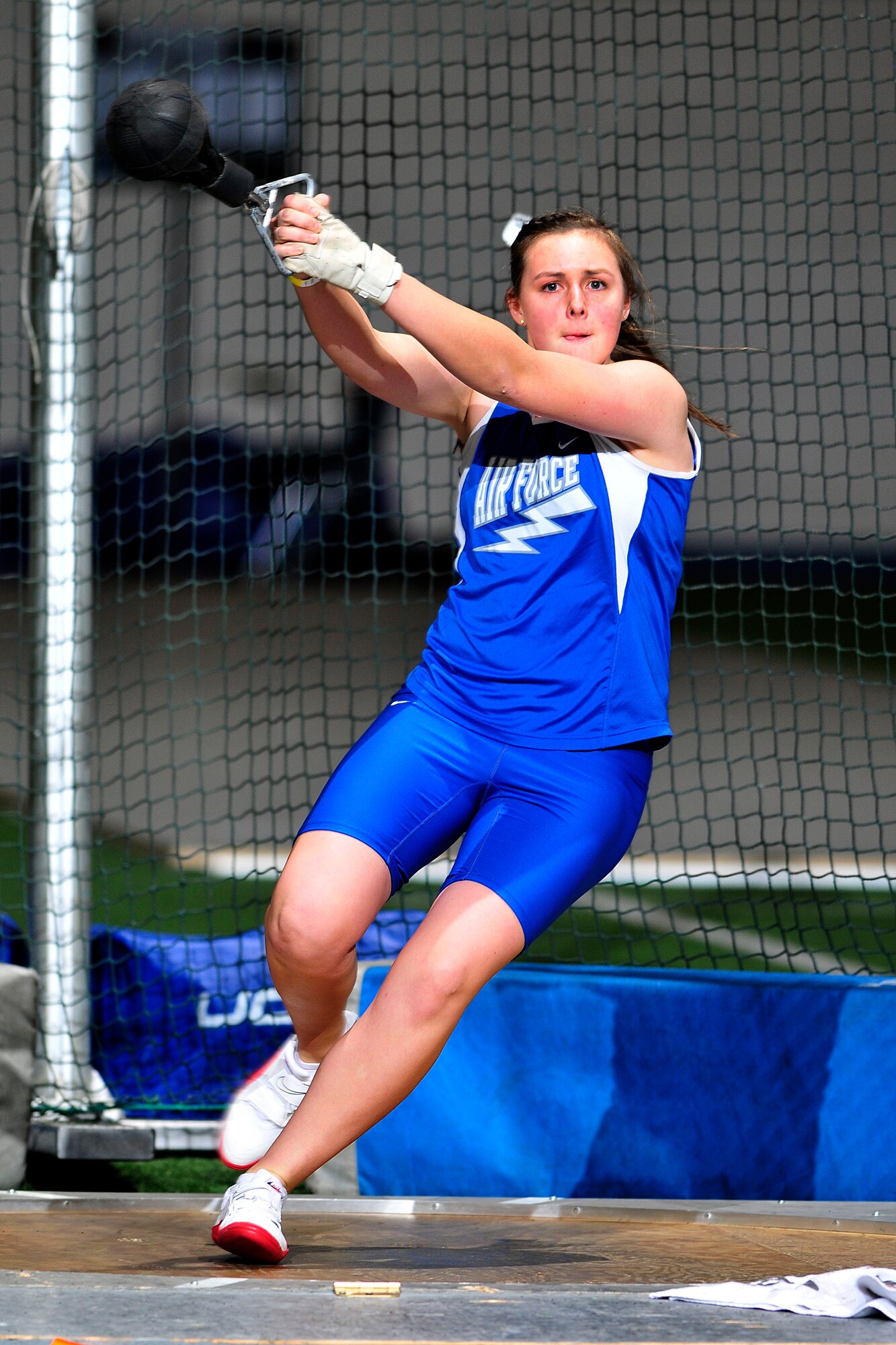 Freshman Becca Bauman throws a weight during a track and field meet Jan. 14, 2011, at the Air Force Academy Cadet Field House. Bauman placed 11th in both the weight throw and shot put events. (U.S. Air Force photo/Bill Evans)