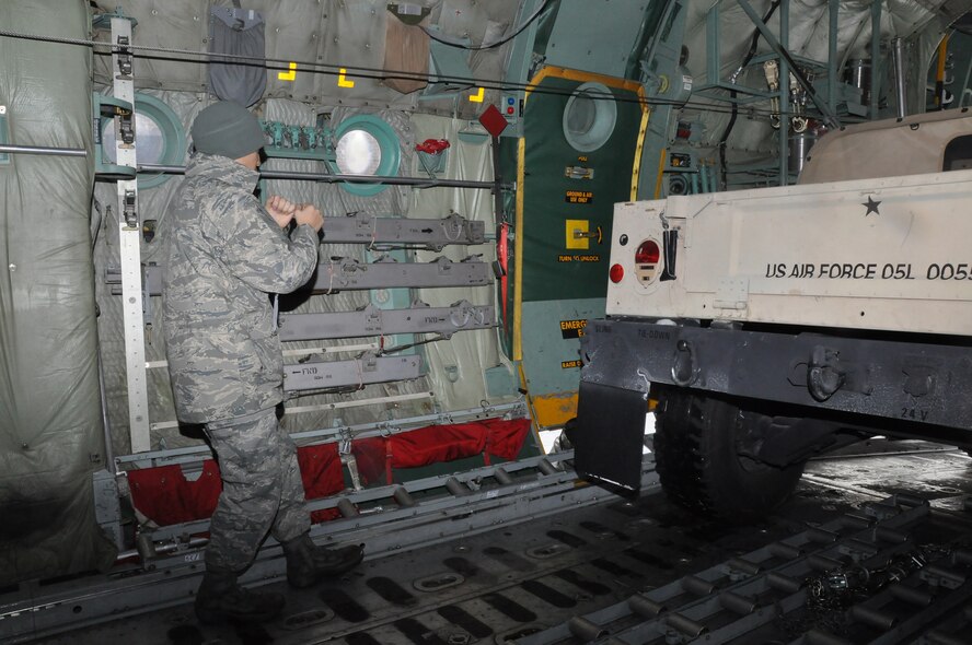 Air transportation specialists from the 27th Aerial Port Squadron, load a Humvee during a simulated aircraft load at the Minneapolis-St. Paul IAP ARS, Minn. (Air Force Photo/Tech. Sgt. Bob Sommer)