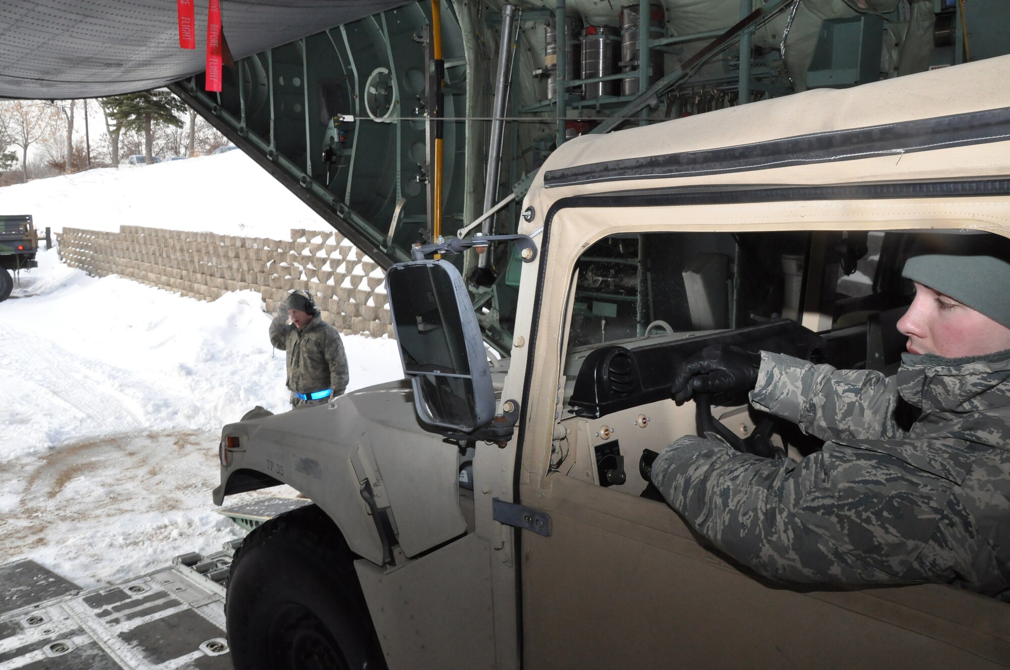 Air transportation specialists from the 27th Aerial Port Squadron, load a Humvee during a simulated aircraft load at the Minneapolis-St. Paul IAP ARS, Minn. (Air Force Photo/Tech. Sgt. Bob Sommer)
