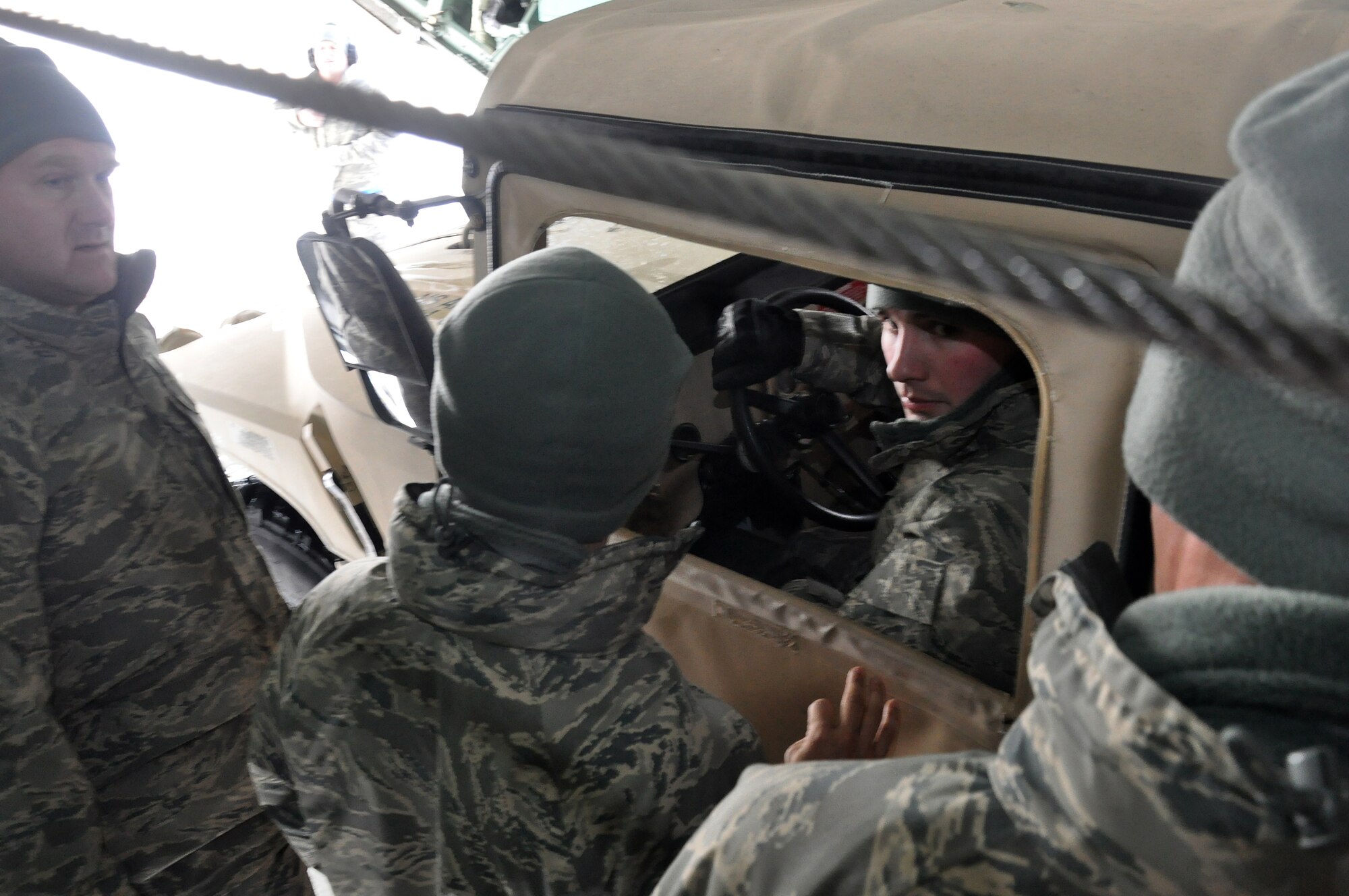 Air transportation specialists from the 27th Aerial Port Squadron, load a Humvee during a simulated aircraft load at the Minneapolis-St. Paul IAP ARS, Minn. (Air Force Photo/Tech. Sgt. Bob Sommer)