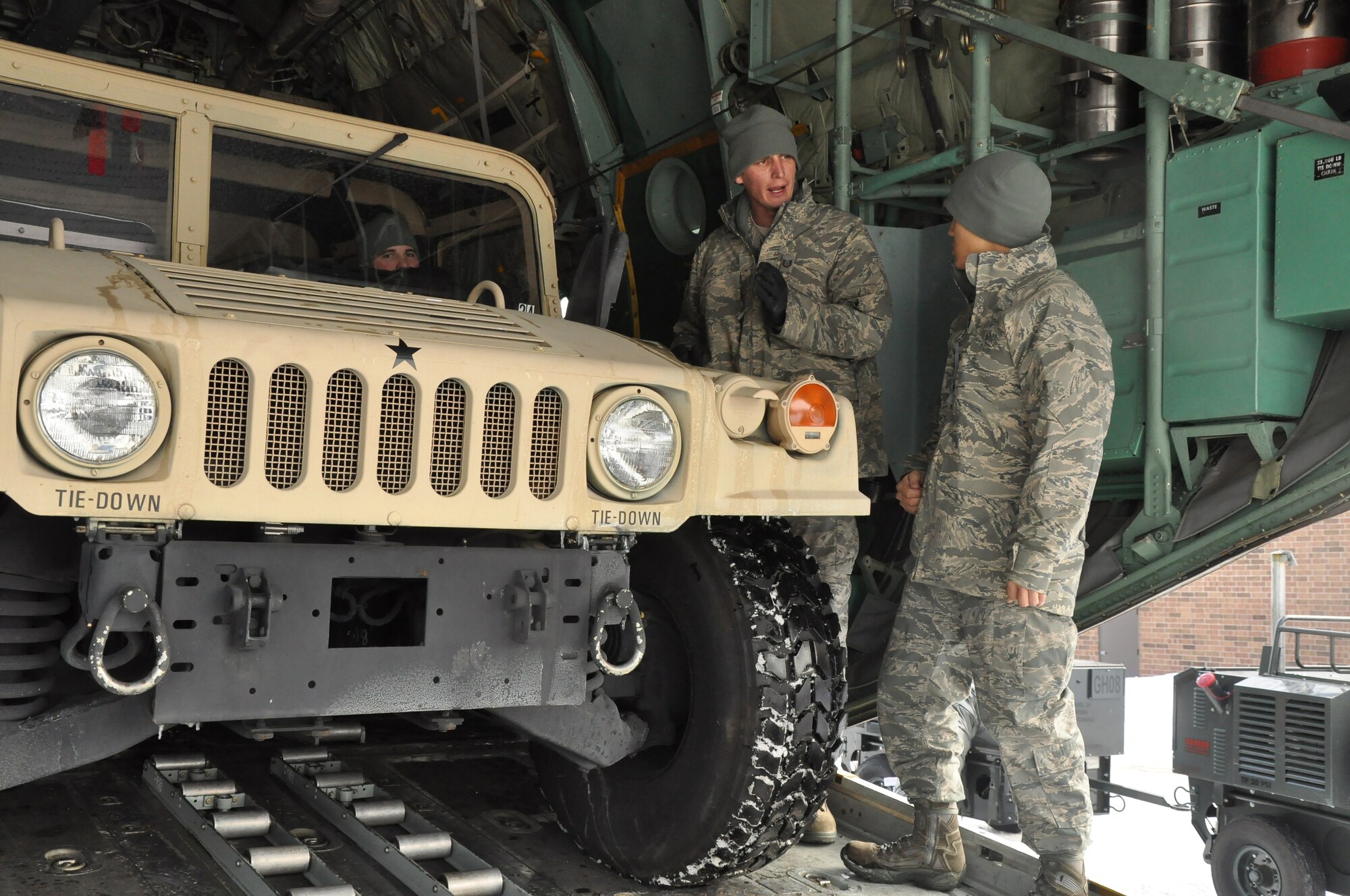 Air transportation specialists from the 27th Aerial Port Squadron, load a Humvee during a simulated aircraft load at the Minneapolis-St. Paul IAP ARS, Minn. (Air Force Photo/Tech. Sgt. Bob Sommer)