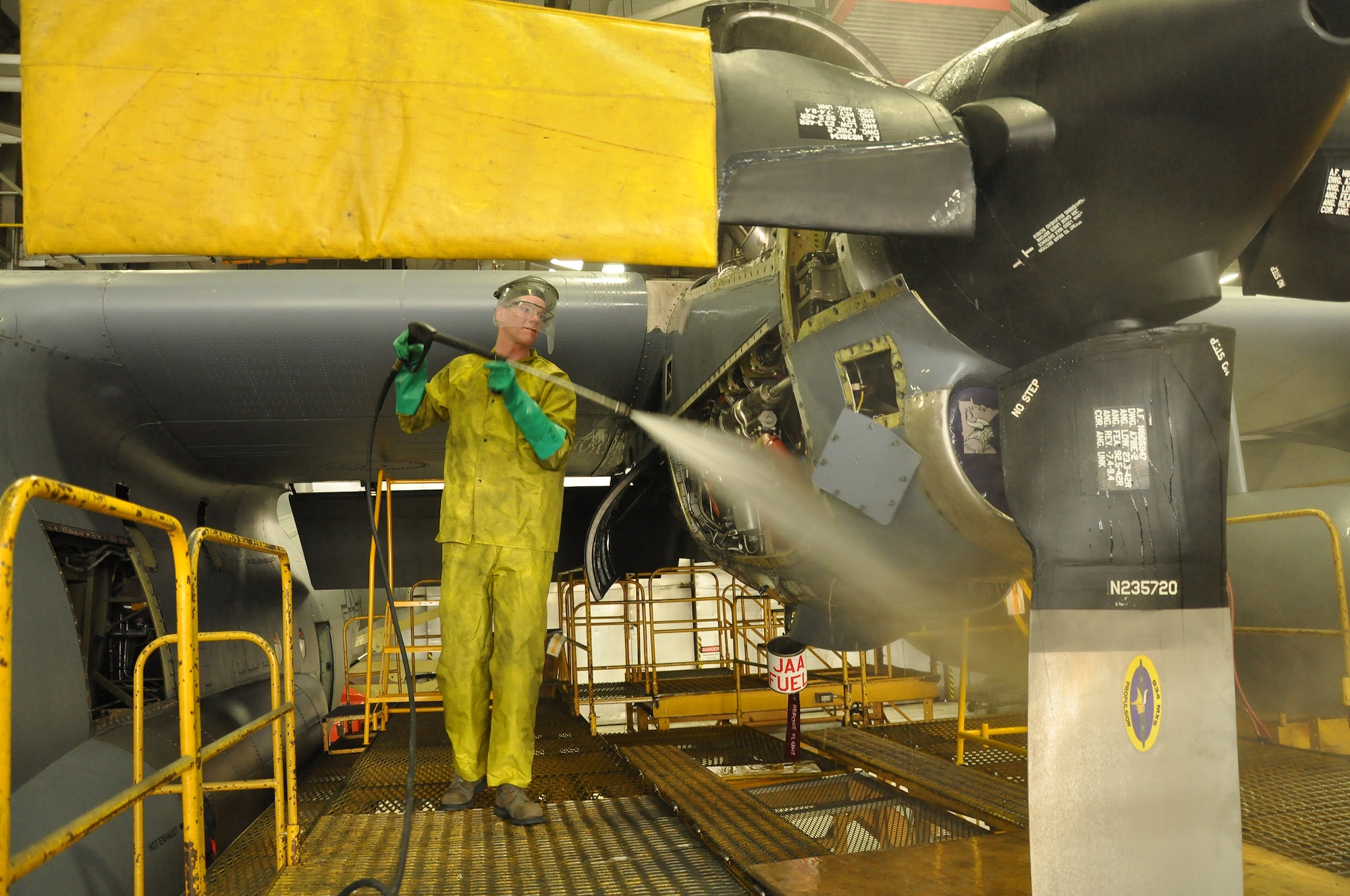 Airman,Christopher Becker 934th Maintenance Squadron engine specialist, washes down the engine of a C-130 Hercules at the Minneapolis-St. Paul IAP ARS, Minn (Air Force Photo/Tech. Sgt. Bob Sommer)