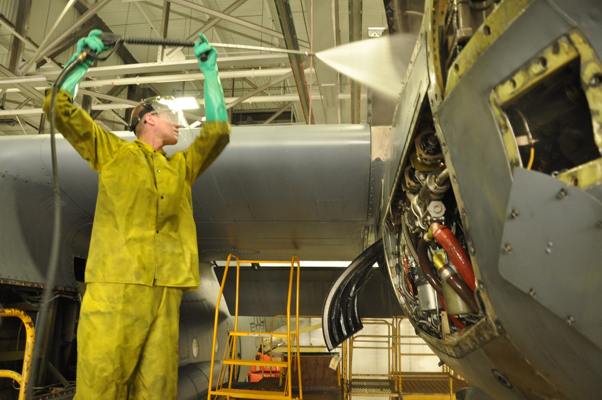 Airman,Christopher Becker 934th Maintenance Squadron engine specialist, washes down the engine of a C-130 Hercules at the Minneapolis-St. Paul IAP ARS, Minn (Air Force Photo/Tech. Sgt. Bob Sommer)