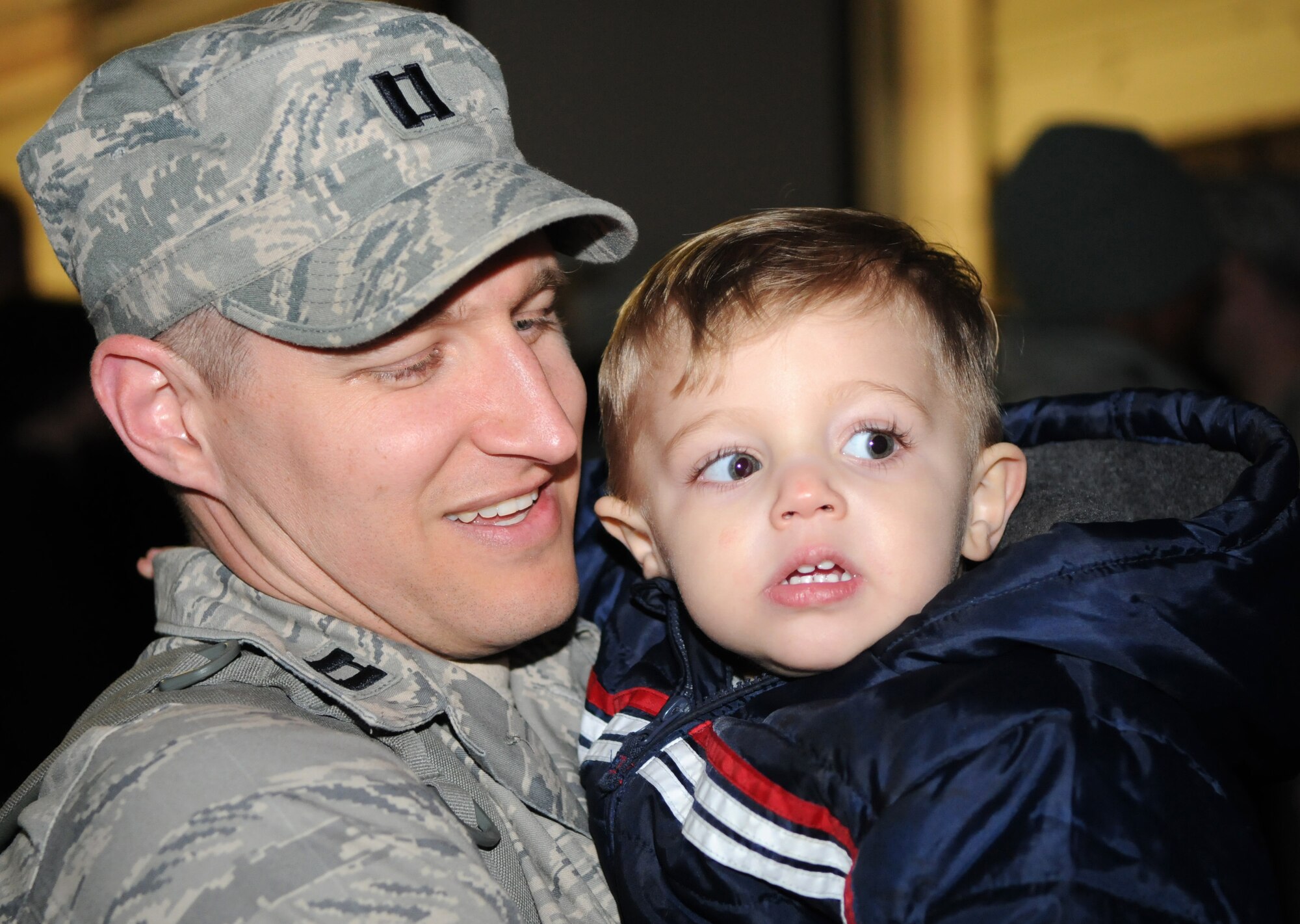 SPANGDAHLEM AIR BASE, Germany – Staff Sgt. John Reeves, 606th Air Control Squadron weapons director, kisses his daughter for the first time after returning home from deployment Jan. 17. Sergeant Reeves’s wife, Stefanie, greeted him with their newborn baby, Sofie, who was born while he was deployed. Seventy-one Airmen from the 606th ACS returned from bases in Southeast Asia and Kandahar Airfield, Afghanistan. Family members and fellow servicemembers waited to greet the Airmen upon their return here after 6- and 7-month deployments. (U.S. Air Force photo/Airman 1st Class Matthew B. Fredericks)
1/19/2011 - SPANGDAHLEM AIR BASE, Germany – Capt. Andrew Babiarz, 606th Air Control Squadron chief of weapons and tactics, holds his son Ethan after returning home from his deployment Jan. 17. Seventy-one Airmen from the 606th ACS returned from bases in Southeast Asia and Kandahar Airfield, Afghanistan. Family members and fellow servicemembers waited to greet the Airmen upon their return here after 6- and 7-month deployments. (U.S. Air Force photo/Airman 1st Class Matthew B. Fredericks) 
