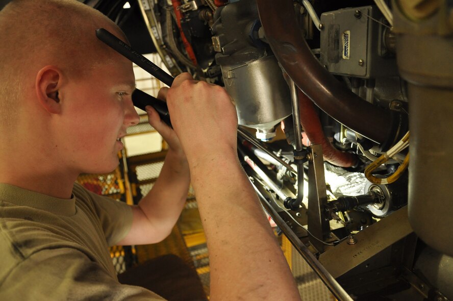 Airman,Christopher Becker, 934th Maintenance Squadron engine specialist, inspects the engine of a C-130 Hercules at the Minneapolis-St. Paul IAP ARS, Minn (Air Force Photo/Tech. Sgt. Bob Sommer)