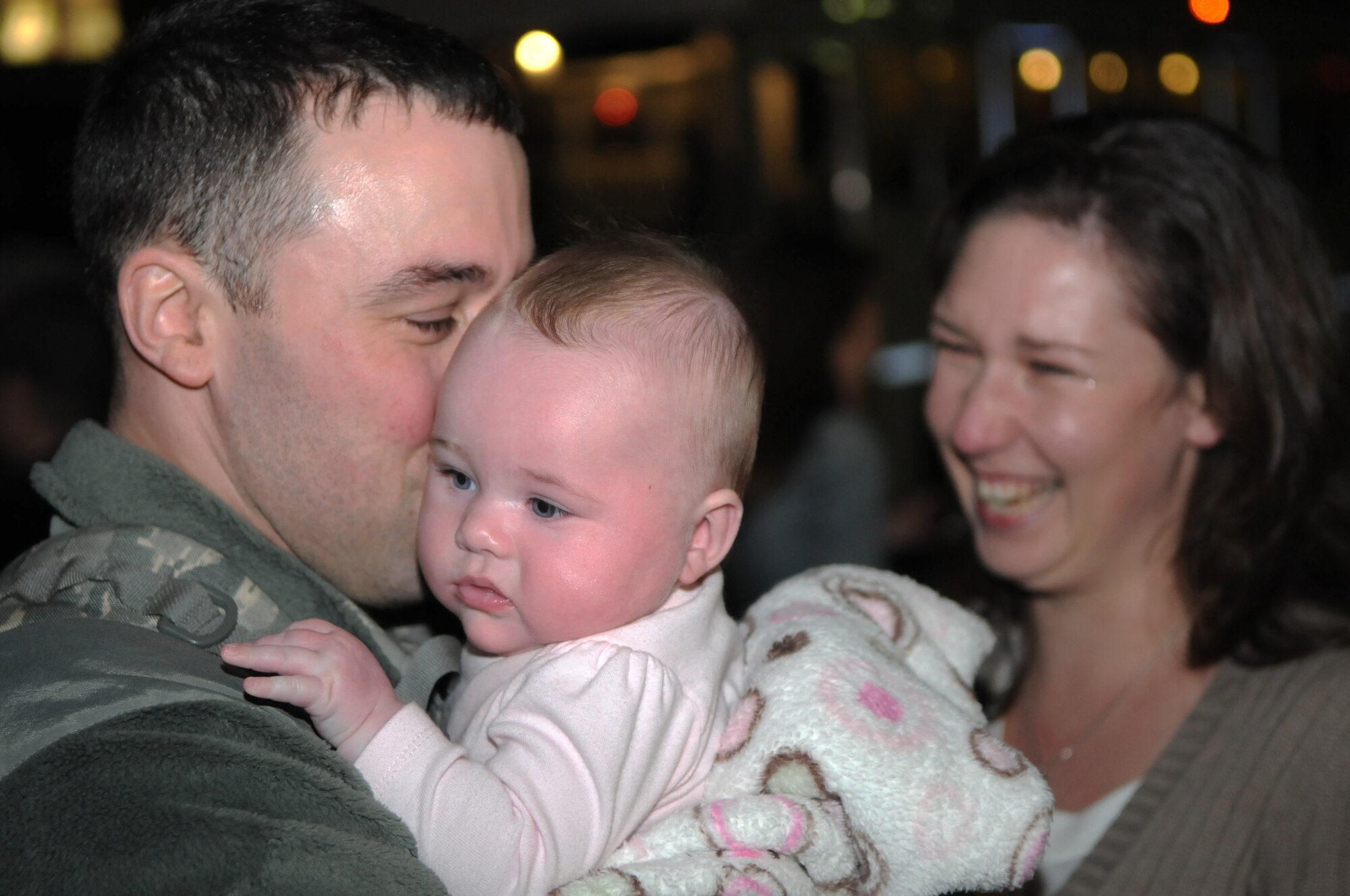 SPANGDAHLEM AIR BASE, Germany – Staff Sgt. John Reeves, 606th Air Control Squadron weapons director, kisses his daughter for the first time after returning home from deployment Jan. 17. Sergeant Reeves’s wife, Stefanie, greeted him with their newborn baby, Sofie, who was born while he was deployed. Seventy-one Airmen from the 606th ACS returned from bases in Southeast Asia and Kandahar Airfield, Afghanistan. Family members and fellow servicemembers waited to greet the Airmen upon their return here after 6- and 7-month deployments. (U.S. Air Force photo/Airman 1st Class Matthew B. Fredericks)
1/19/2011 - SPANGDAHLEM AIR BASE, Germany – Capt. Andrew Babiarz, 606th Air Control Squadron chief of weapons and tactics, holds his son Ethan after returning home from his deployment Jan. 17. Seventy-one Airmen from the 606th ACS returned from bases in Southeast Asia and Kandahar Airfield, Afghanistan. Family members and fellow servicemembers waited to greet the Airmen upon their return here after 6- and 7-month deployments. (U.S. Air Force photo/Airman 1st Class Matthew B. Fredericks) 