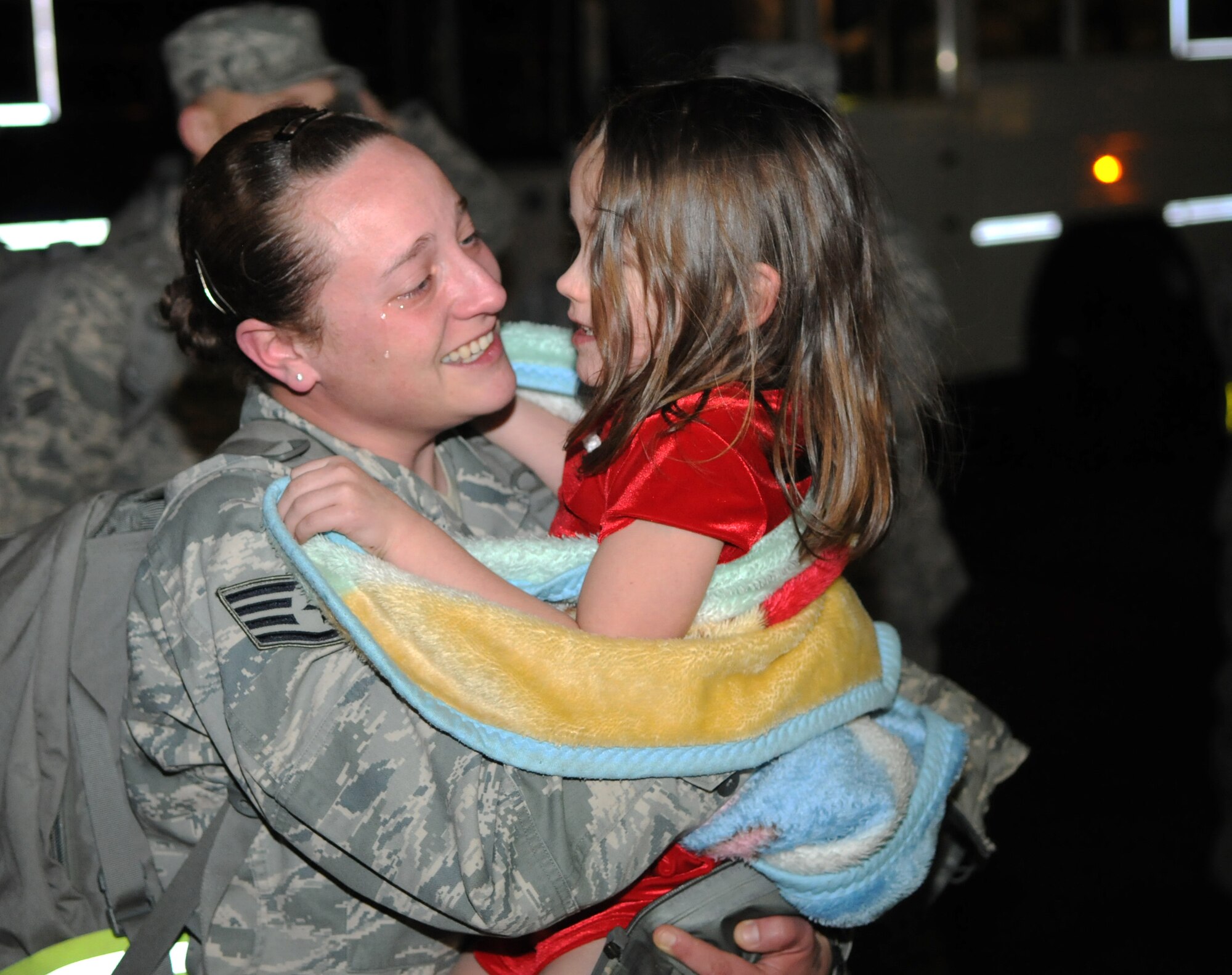 SPANGDAHLEM AIR BASE, Germany – Staff Sgt. Crystal Cox, 606th Air Control Squadron interface control technician, embraces her daughter after returning home from deployment Jan. 17. Seventy-one Airmen from the 606th ACS returned from bases in Southeast Asia and Kandahar Airfield, Afghanistan. Family members and fellow servicemembers waited to greet the Airmen upon their return here after 6- and 7-month deployments. (U.S. Air Force photo/Airman 1st Class Matthew B. Fredericks) 