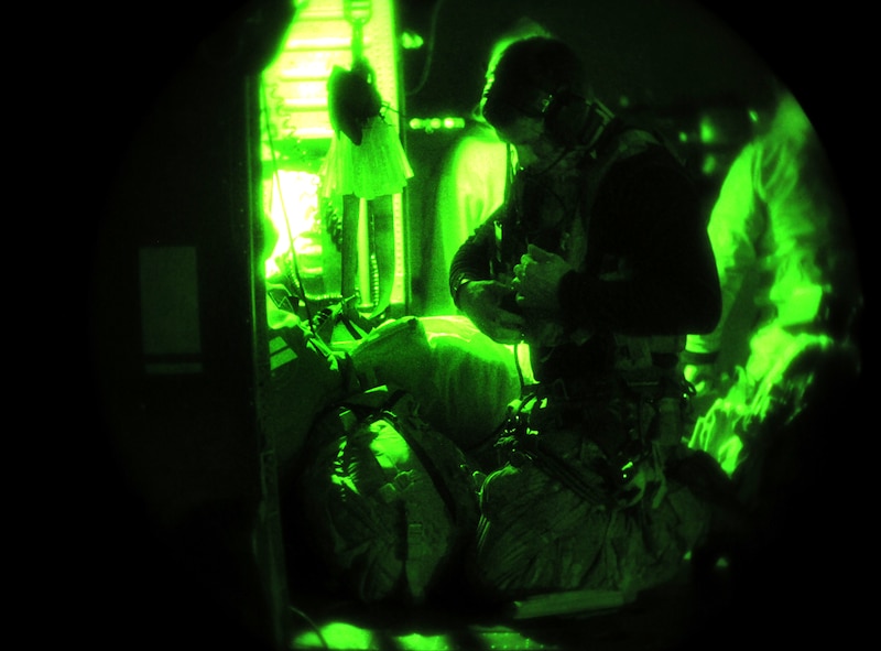 MOODY AIR FORCE BASE, Ga.--1st Lt. Tom Smith, 38th Rescue Squadron combat rescue officer, does a final check through his equipment as he loads into a 41st RQS, HH-60G Pavehawk helicopter Jan. 15. Two pararescueman were loaded into each helicopter before traveling to aid local authorities with the search and rescue of a local missing teenager.  (U.S. Air Force photo/Airman 1st Class Benjamin Wiseman)(RELEASED)