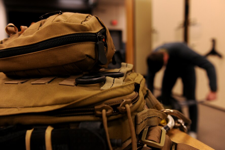 MOODY AIR FORCE BASE, Ga.-- Gear worn by 38th Rescue Squadron pararescuemen sits as Senior Airmen Matthew Blankenship, 38th RQS pararescueman, dons his cold weather gear before conducting a search and rescue mission Jan. 15. Moody personnel aided local authorities in the search for a missing local teenager. (U.S. Air Force photo/Airman 1st Class Benjamin Wiseman)(RELEASED)
