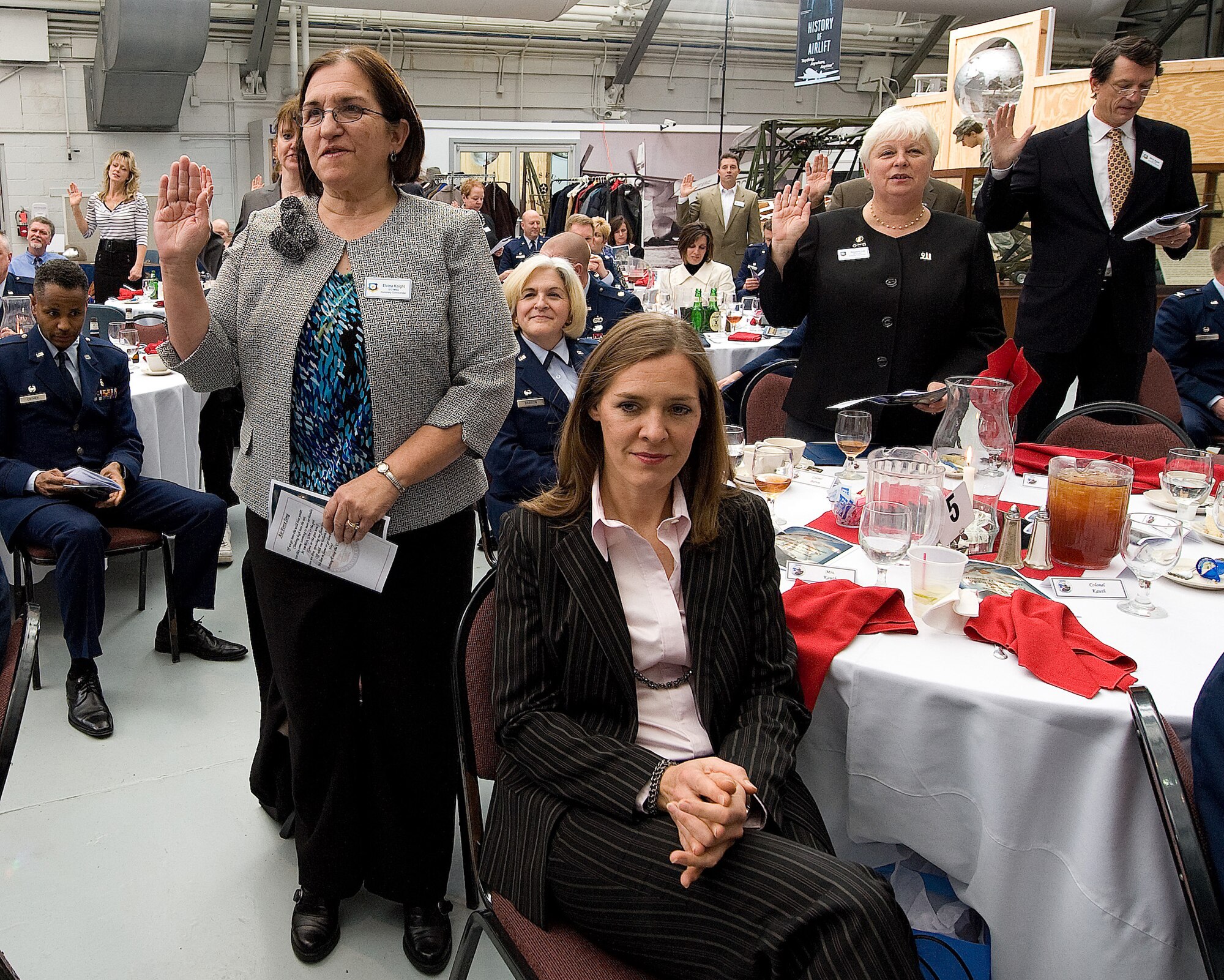 Honorary commanders get sworn in by stating the oath during the Dover Air Force Base, Del., 2011 Honorary Commanders Induction Ceremony Jan. 7, 2011. The oath formally inducts the commanders into position of honorary commander, and was lead by Col. Manson Morris, 436th Airlift Wing commander. (U.S. Air Force photo/Jason Minto)