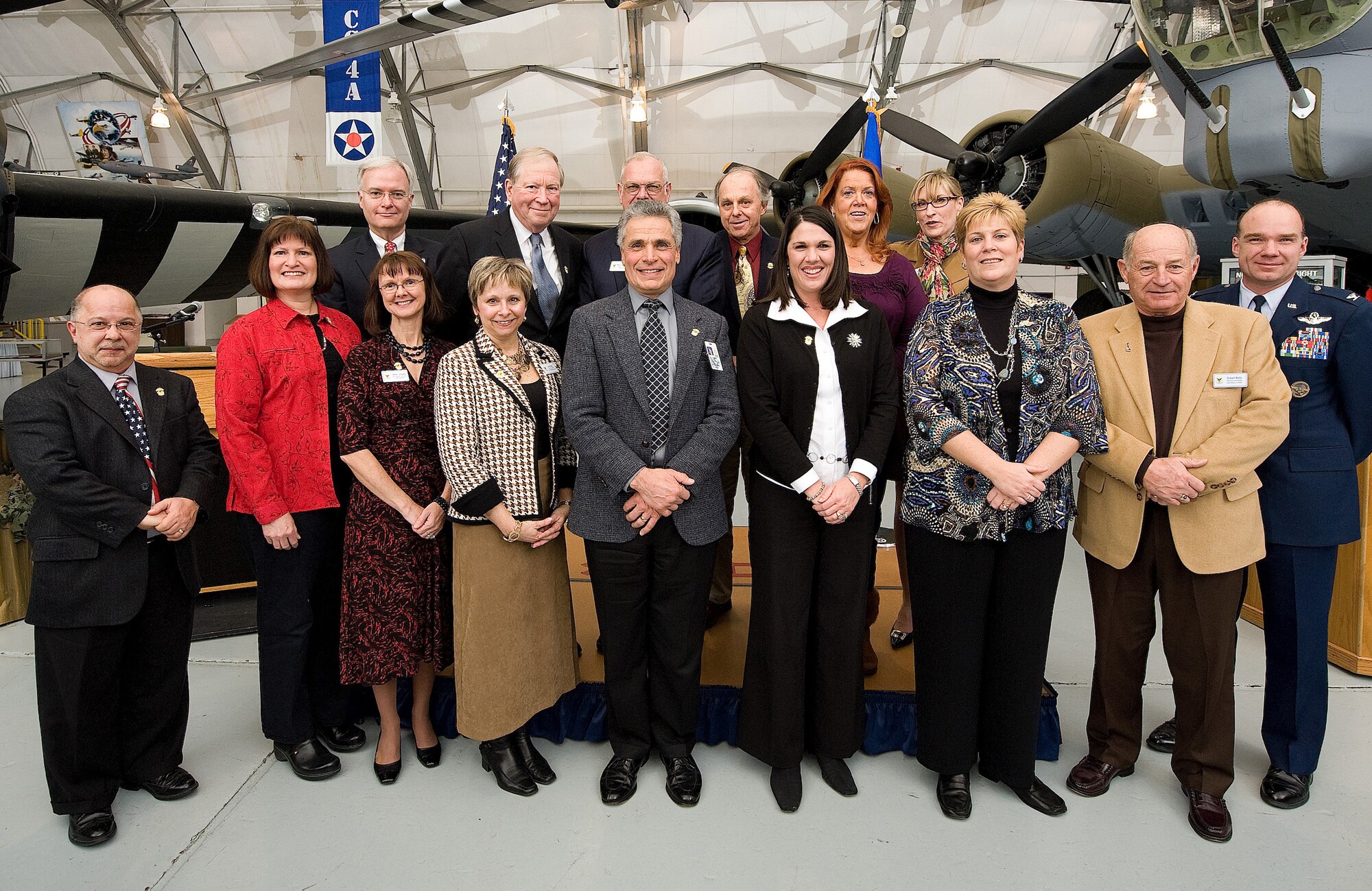The Honorary Commanders Alumni Association come together for a group photo after being presented with their alumni association pins during the Dover Air Force Base, Del., 2011 Honorary Commanders Induction Ceremony Jan. 7, 2011. This is the alumni association's first year. The alumni association is comprised of former honorary commanders who have served over the years. (U.S. Air Force photo/Jason Minto)