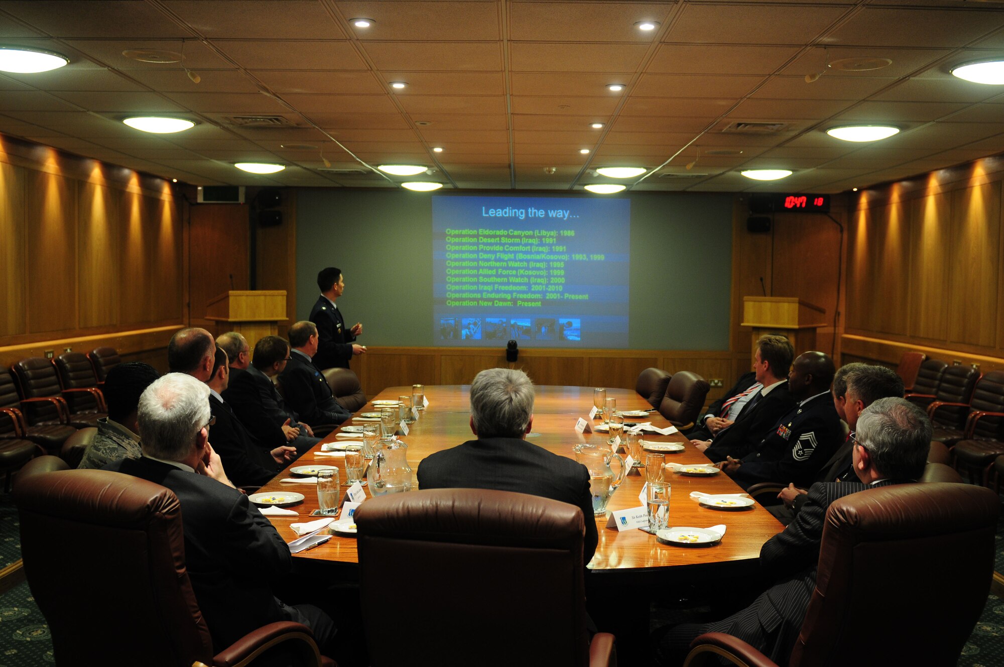 ROYAL AIR FORCE LAKENHEATH, England - Col. John Quintas, 48th Fighter Wing commander, gives a unit mission brief to the Right Honorable Andrew Lansley, the United Kingdom Secretary of State for Health, National Health Service officials and distinguished visitors on Jan. 14. Minister Lansley visited the 48th FW to learn about the mission as well as the capabilities of 48th Medical Group and their partnerships with the National Health Service. (U.S. Air Force photo/Staff Sgt. Stephen Linch)