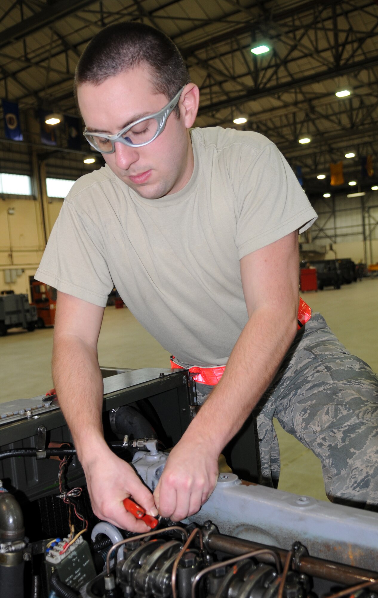 RAF MILDENHALL, England -- Airman 1st Class Chris Corley, 100th Maintenance Squadron Aerospace Ground Equipment mechanic, inserts a cotter pin into an A/M32A-86 diesel generator during a refresher field training course, Jan. 14, 2011 at the AGE flight. The refresher training is held monthly to ensure all AGE mechanics are familiar with operating procedures. (U.S. Air Force photo/Airman 1st Class Rachel Waller)