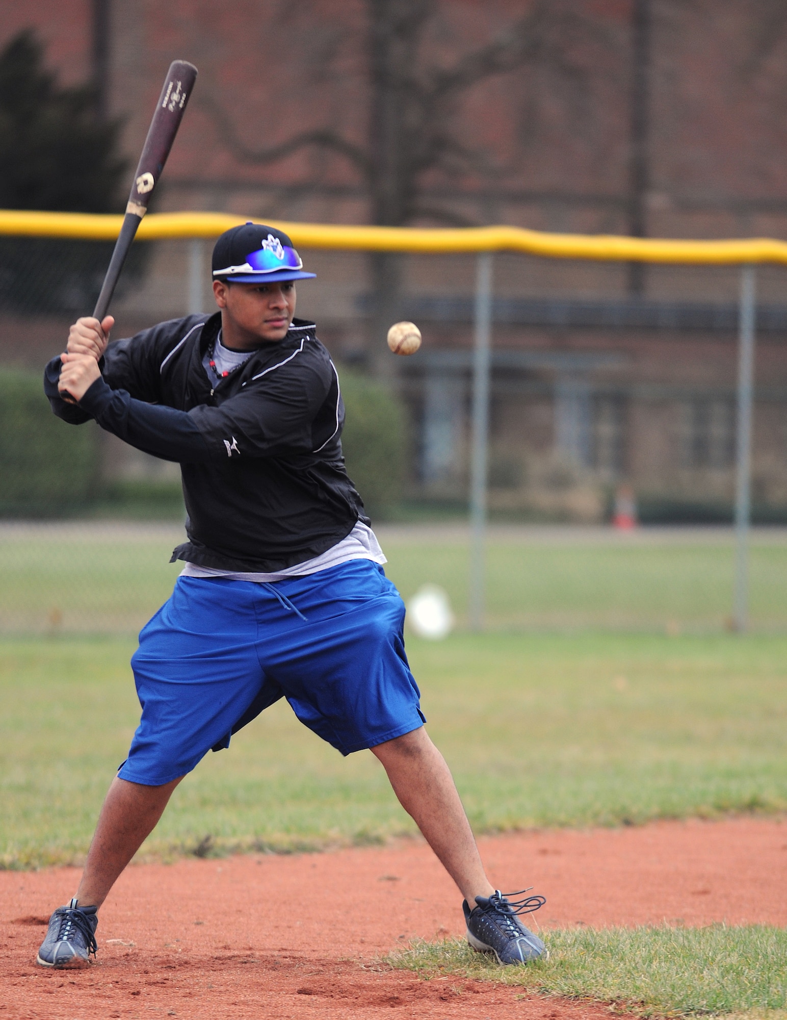 RAF MILDENHALL, England -- Jose Perez, 48th Component Maintenance Squadron aerospace propulsion journeyman, hits a baseball to the infield during tryouts Jan. 15, 2011, at the RAF Feltwell baseball fields.  Members from RAFs Mildenhall, Lakenheath and Feltwell tried out for the Mildenhall Bulldogs. (U.S. Air Force photo/Senior Airman Tabitha M. Lee)