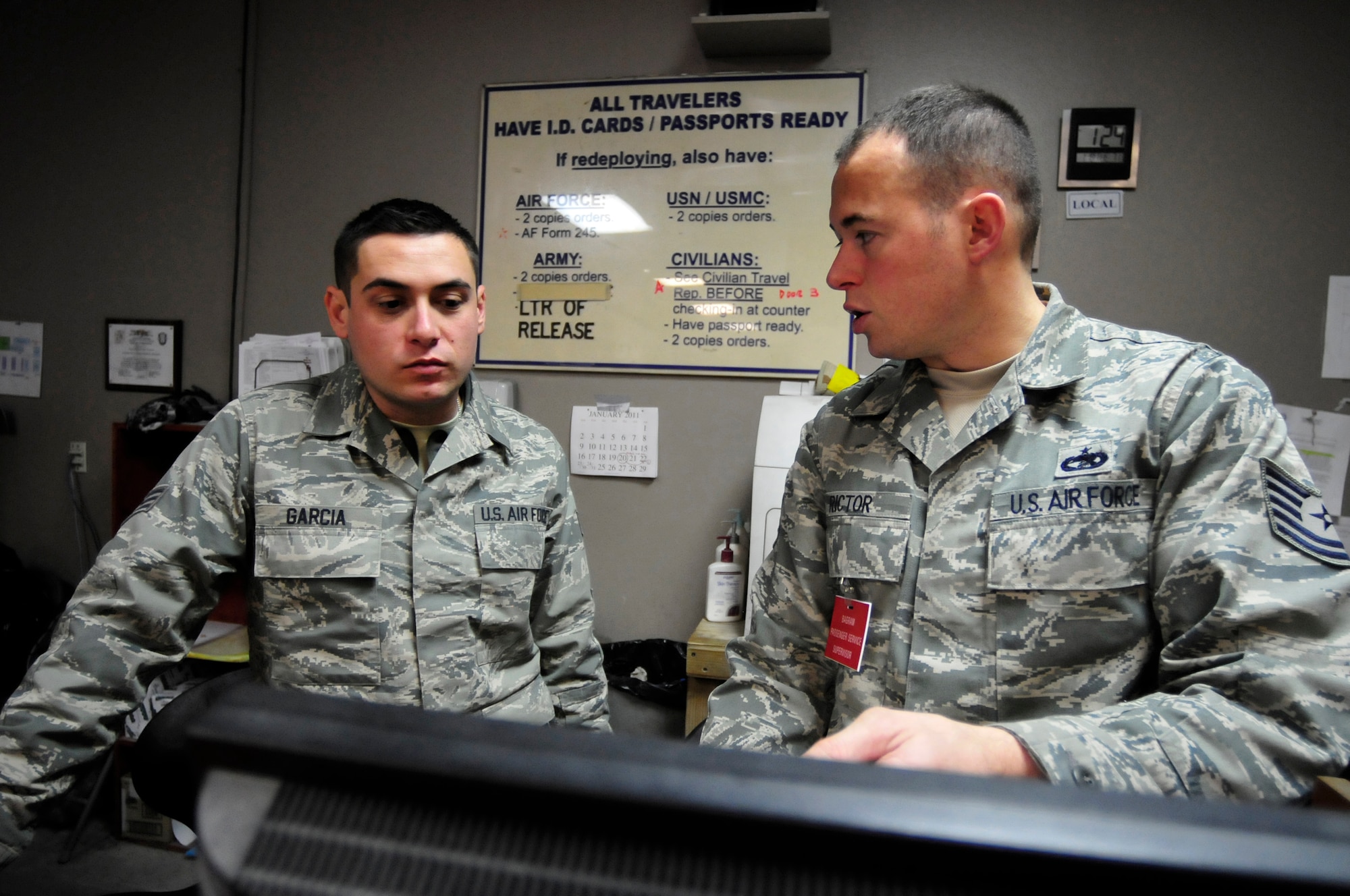 455th Expeditionary Aerial Port Squadron Passenger Service Supervisor, Tech. Sgt. Jason Rictor trains Senior Airman Phil Garcia during his first day at Bagram Airfield, Jan. 18, 2011. Sergeant Rictor has been here for only a week and has already learned how the Air Force's busiest passenger terminal handles nearly 1800 daily passengers. Sergeant Rictor is a Gresham, Ore., native deployed from Travis Air Force Base, Calif., and Airman Garcia is a Grand Terrace, Calif., native deployed from March Air Force Base, Calif. (U.S. Air Force photo by Tech. Sgt. Michael Voss)