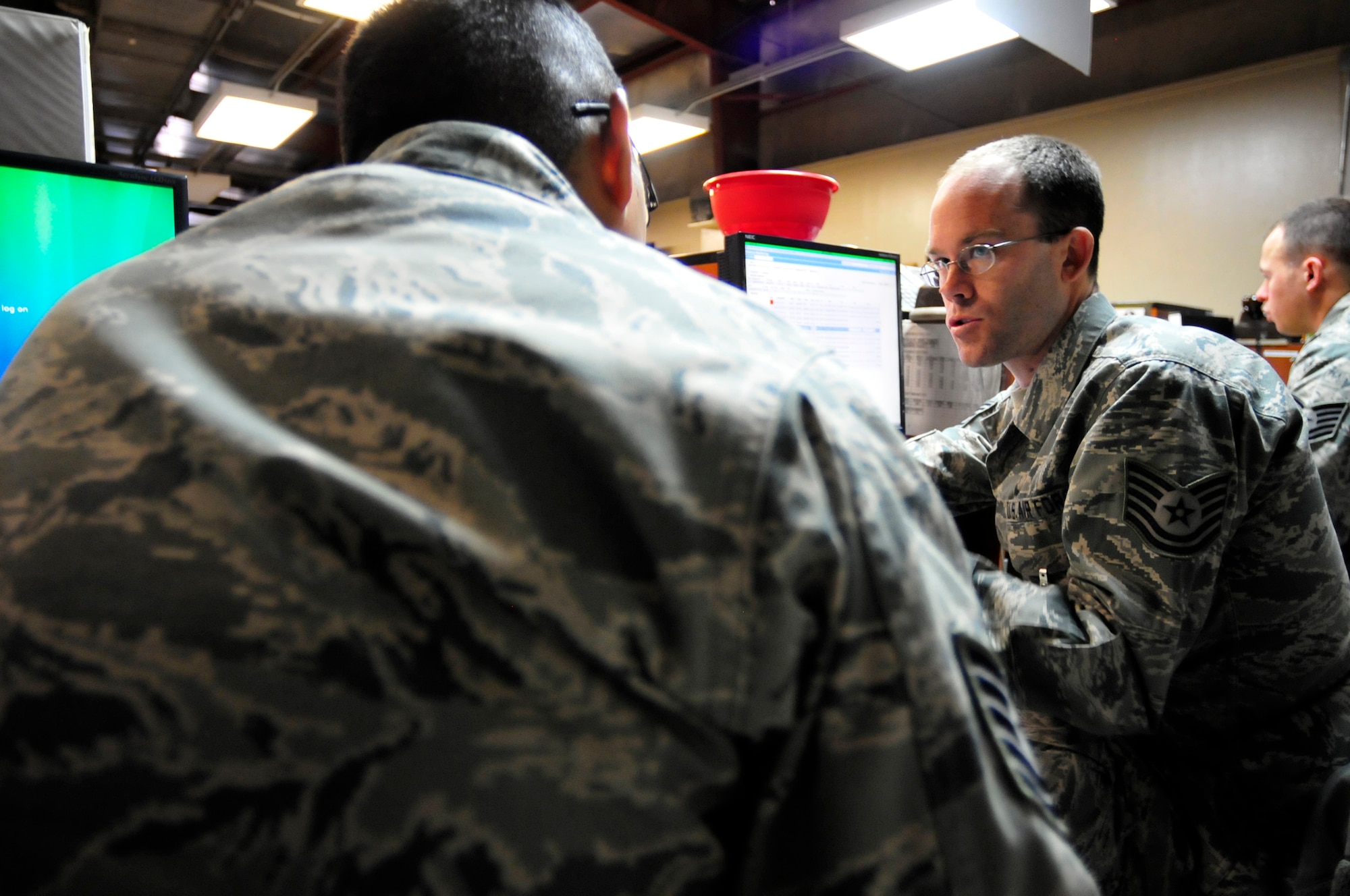 455th Expeditionary Aerial Port Squadron Passenger Terminal Supervisor, Tech. Sgt. Micah Lile trains his replacement Tech. Sgt. Juan Martinez his duties in the Air Force's busiest passenger terminal at Bagram Airfield, Afghanistan, Jan. 18, 2011. Sergeant Lile is a Greenleaf, Colo., native deployed from the 153rd Wyoming Air National Guard and Sergeant Martinez is a Moreno Valley, Calif., native deployed from March Air Force Base, Calif. (Air Force photo by Tech. Sgt. Michael Voss)  