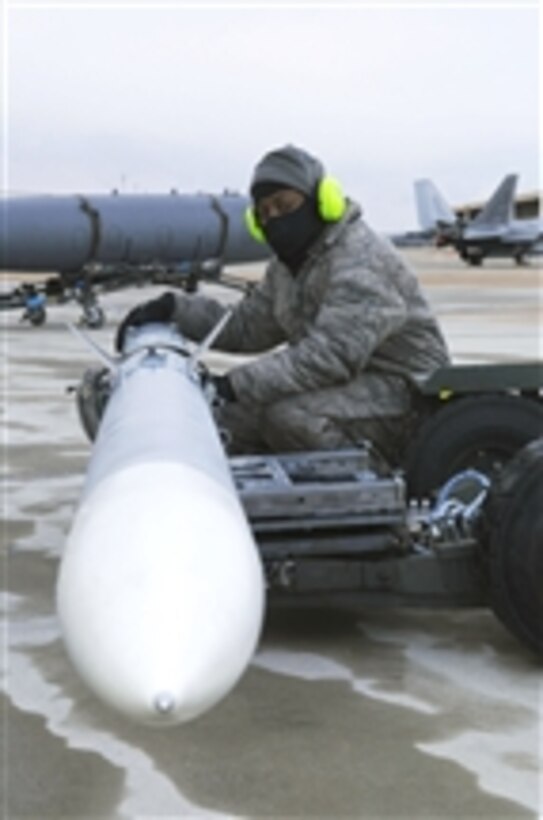 Staff Sgt. Lamont Brown waits for the command to load munitions during an operational readiness exercise at Joint Base Langley Eustis, Va., on Jan. 8, 2011.  The Air Force units on base tested their readiness ability to deploy cargo, aircraft and people within a limited time frame.  Brown is assigned as a weapons load crew chief with the1st Maintenance Squadron.  