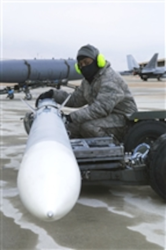 Staff Sgt. Lamont Brown waits for the command to load munitions during an operational readiness exercise at Joint Base Langley Eustis, Va., on Jan. 8, 2011.  The Air Force units on base tested their readiness ability to deploy cargo, aircraft and people within a limited time frame.  Brown is assigned as a weapons load crew chief with the1st Maintenance Squadron.  