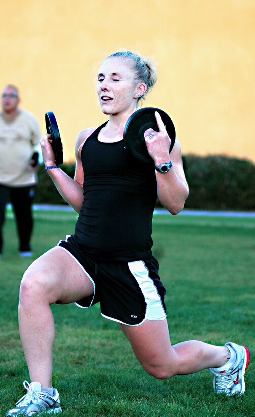 Class instructor and personal trainer for MCRD Semper Fit, Bonnie Axman leads the class in a short weight-training session. Weight-training is combined with aerobics, stretching, and many different types of exercises each week to maximize results.