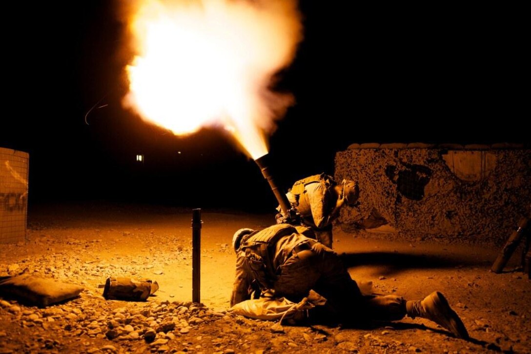 A High Explosive (HE) round is fired from a mortar at a compound in the Green Zone that was shooting at the Sparrowhawk West observation post. FOB Zeebrugge, Kajaki Dam, Helmand Province, Afghanistan. Bravo Company, 1 Marine Divsion, 10th Company.::r::::n::2011/01/19. Picture: JAMES OATWAY.